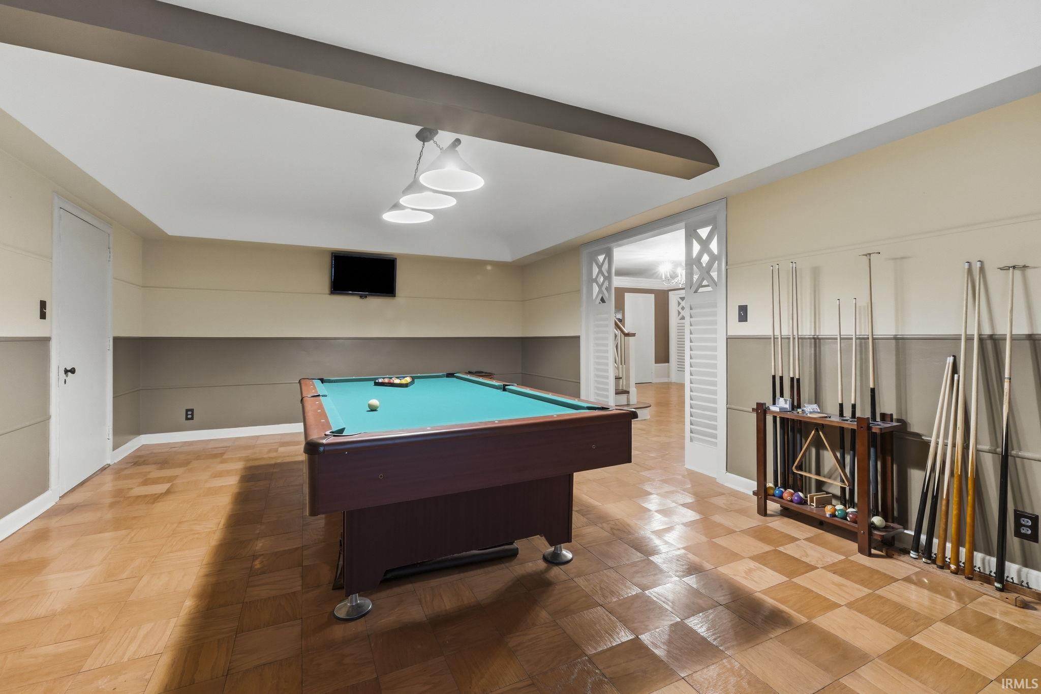 Recessed lighting and a white ceiling with a decorative beam