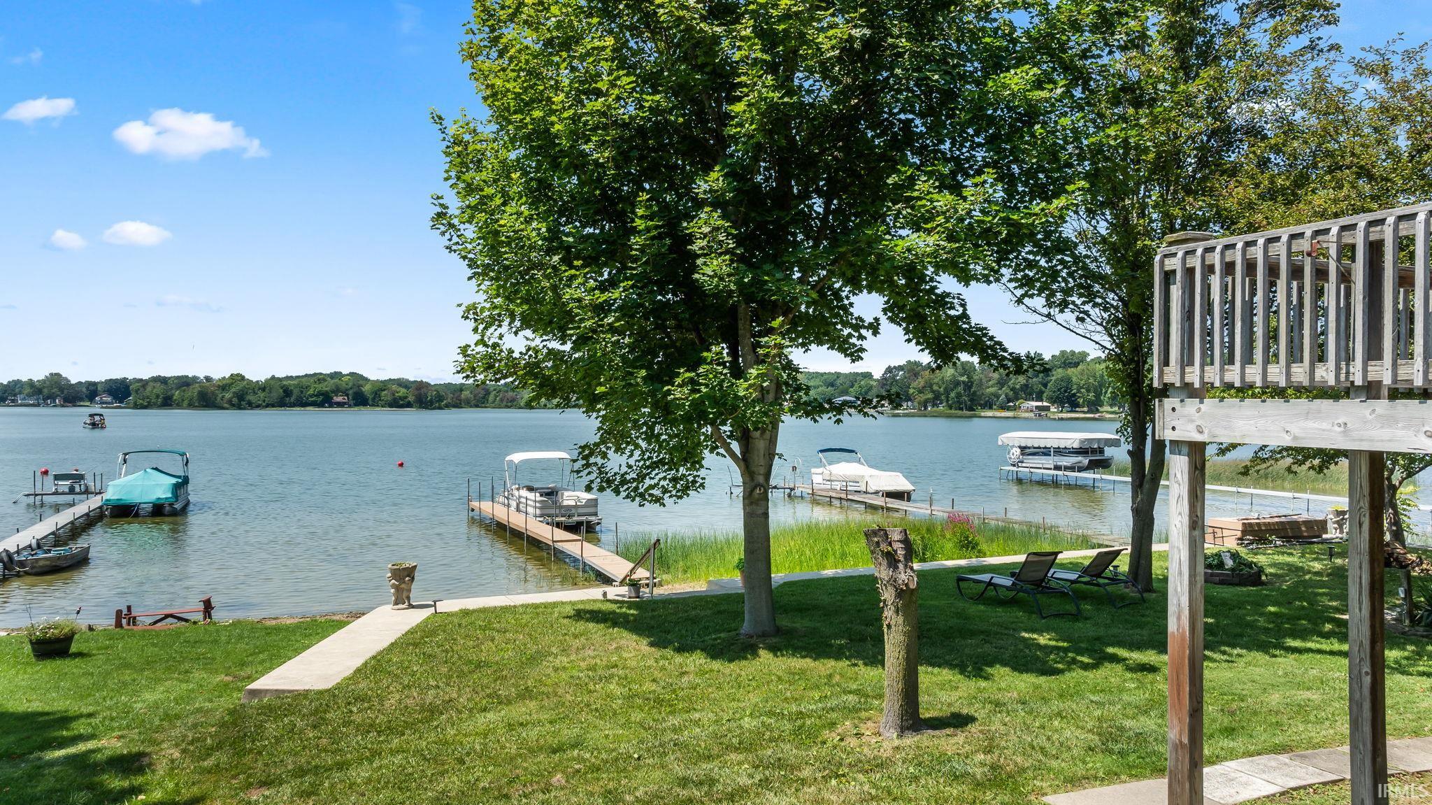 Lakefront property featuring two private docks, direct lake access, and a manicured lawn