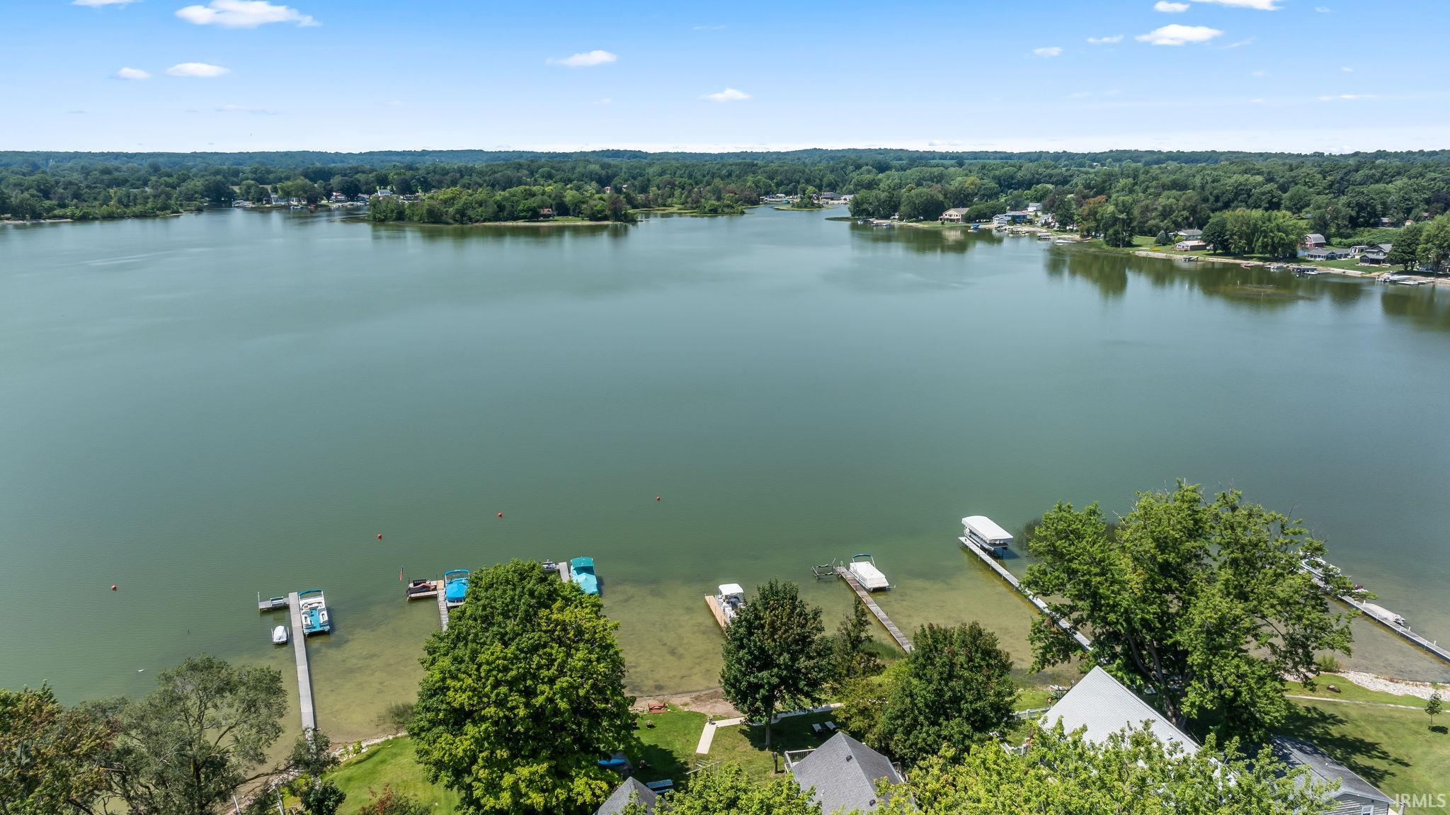 Waterfront property with multiple boat docks and mature trees
