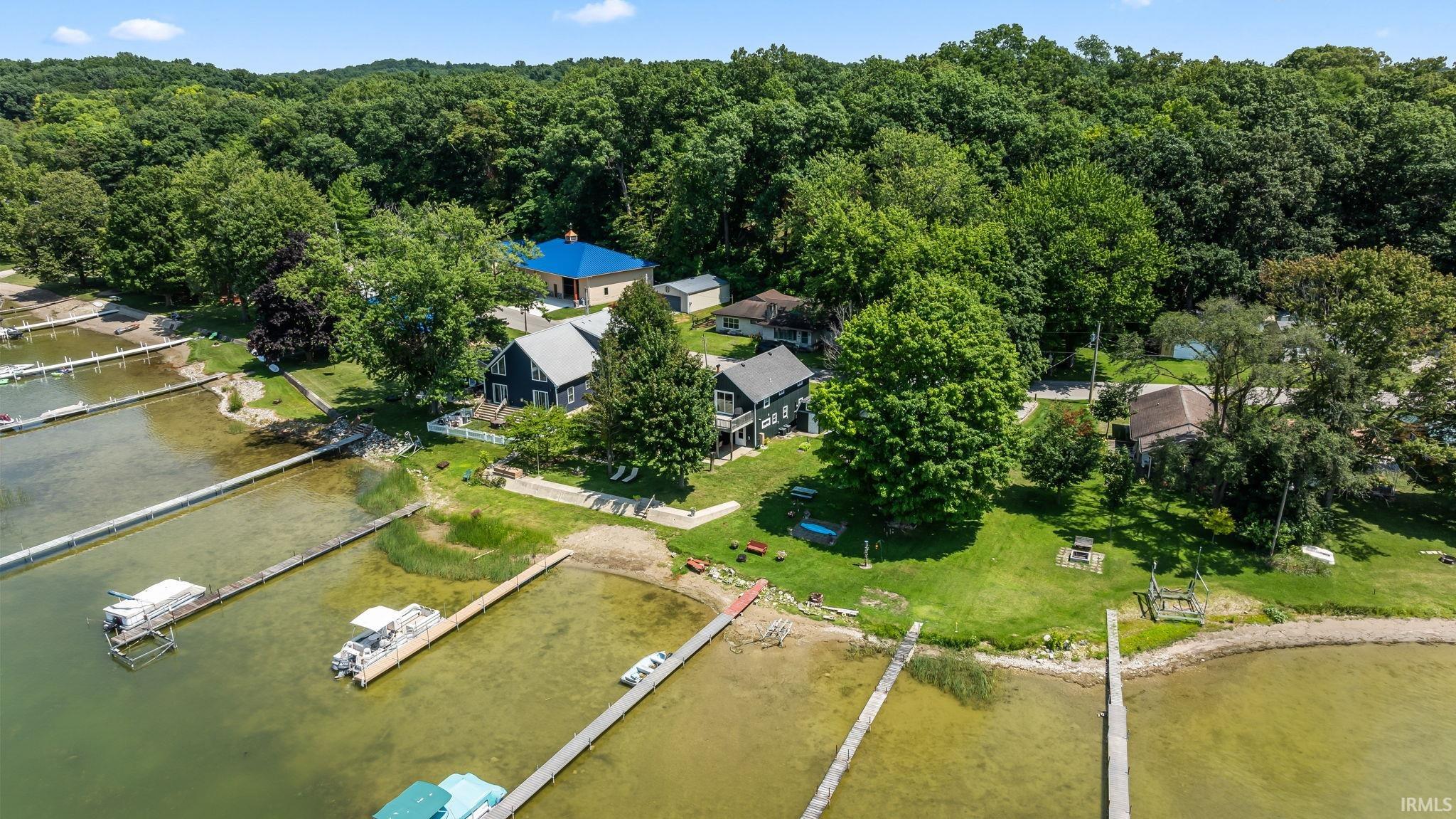 Waterfront property featuring multiple docks, direct water access, and expansive green spaces