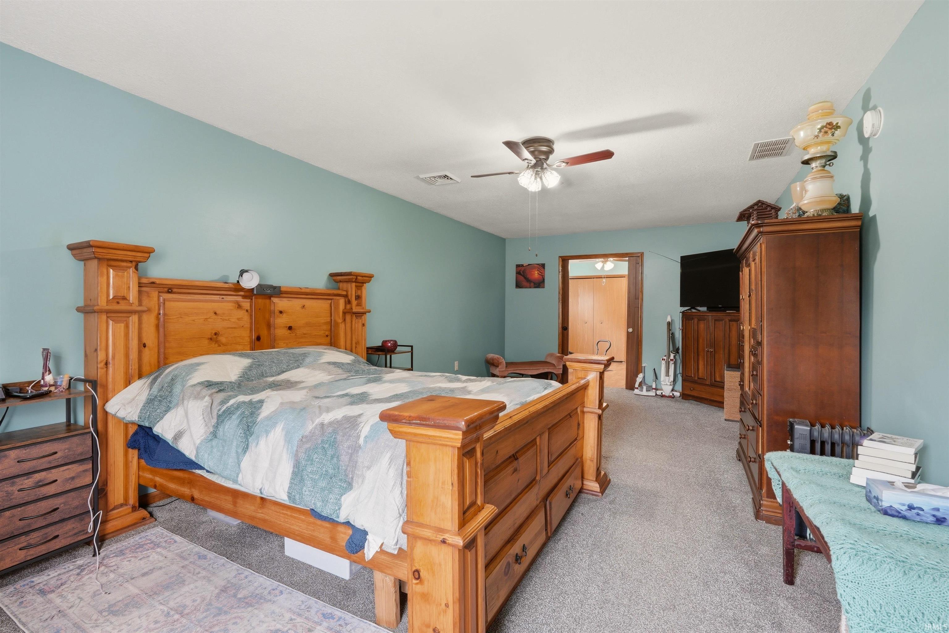 Carpeted flooring, ceiling fan, and painted walls