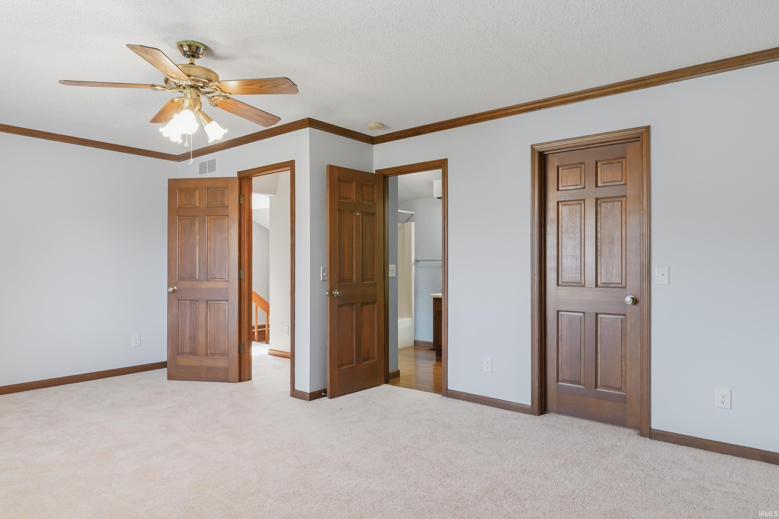 Light-toned wall paint with contrasting wood trim and doors