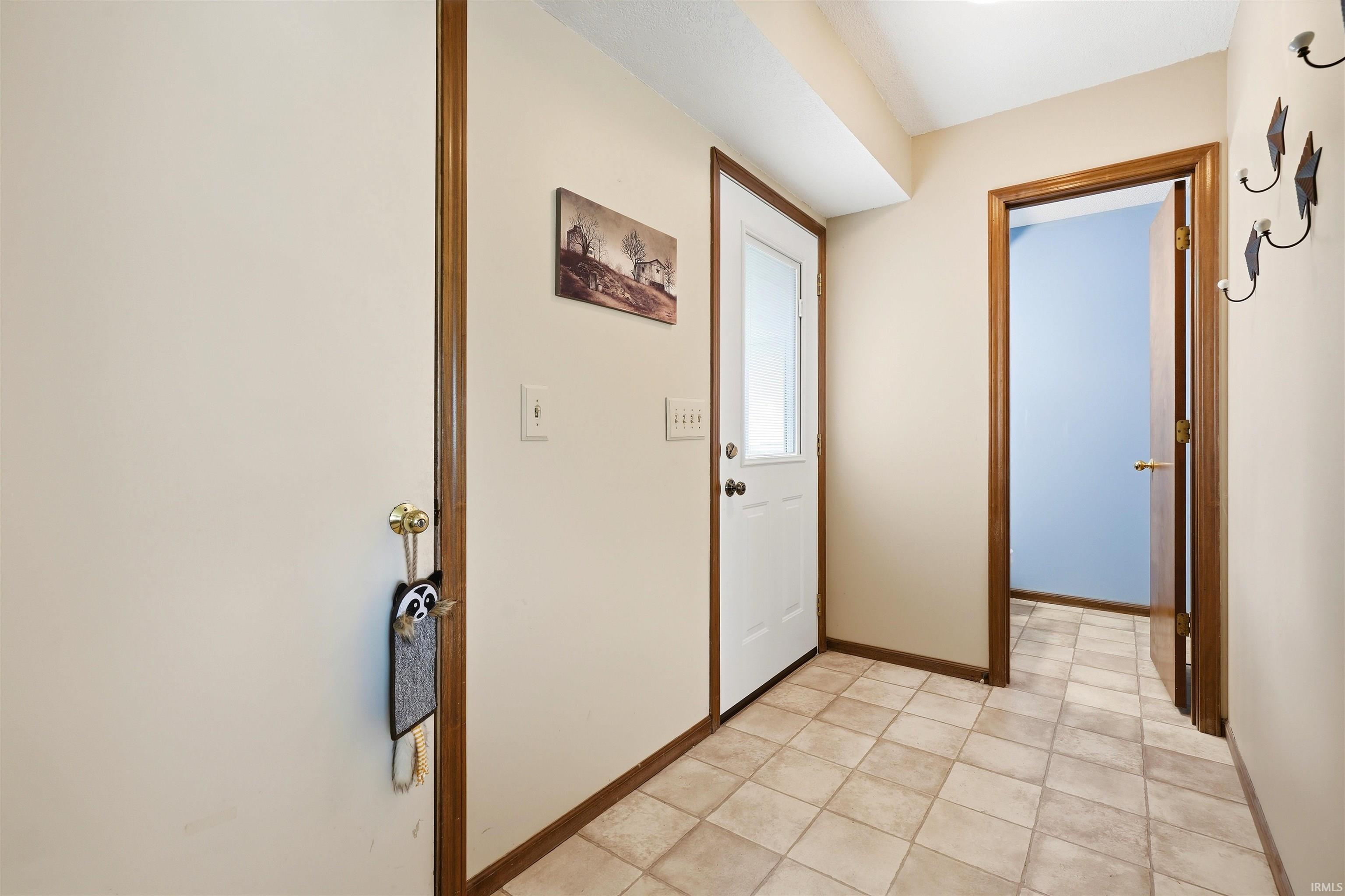Tiled flooring in a neutral tone, complementing the light-colored walls
