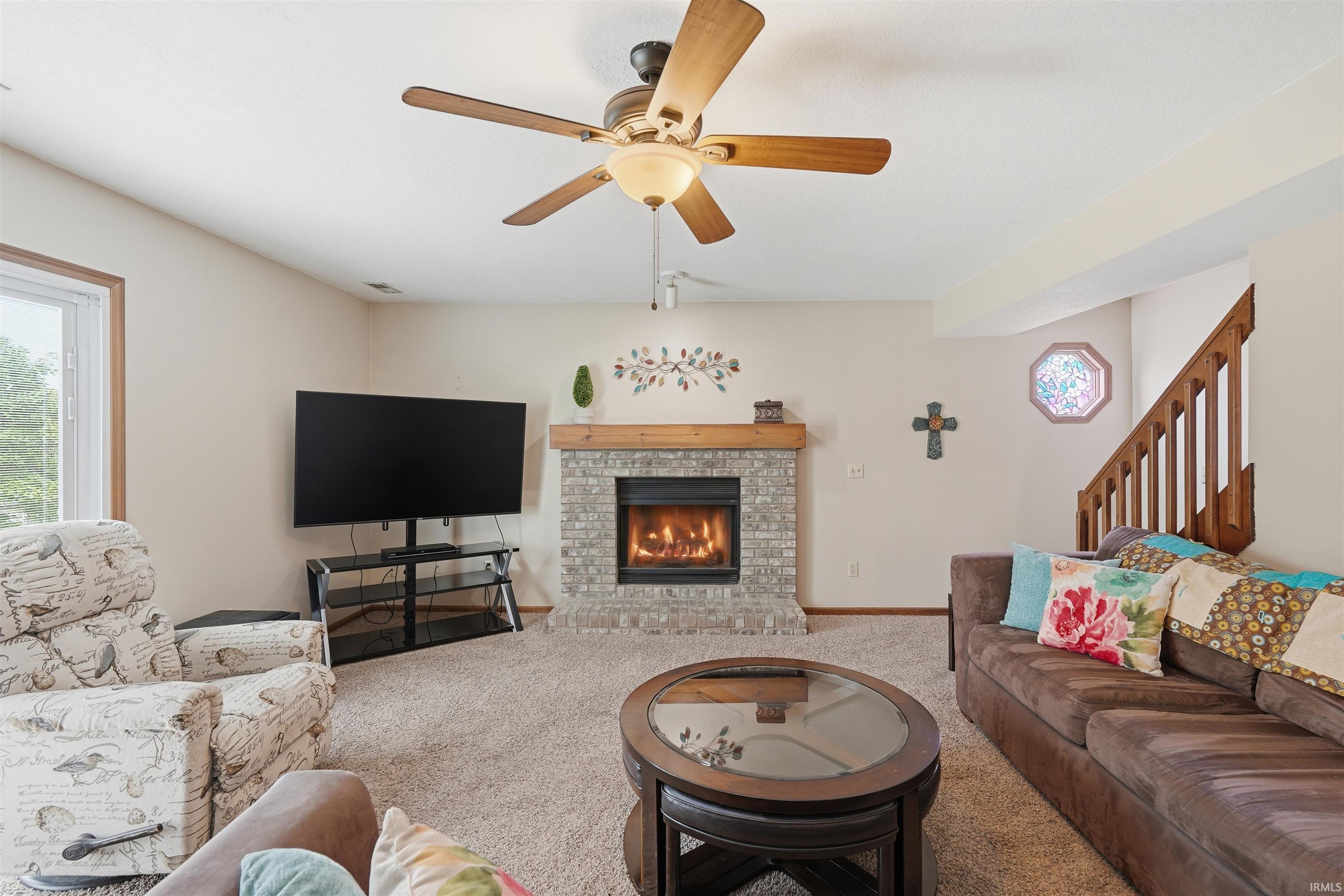 Recessed fireplace with a stone surround and wood mantel