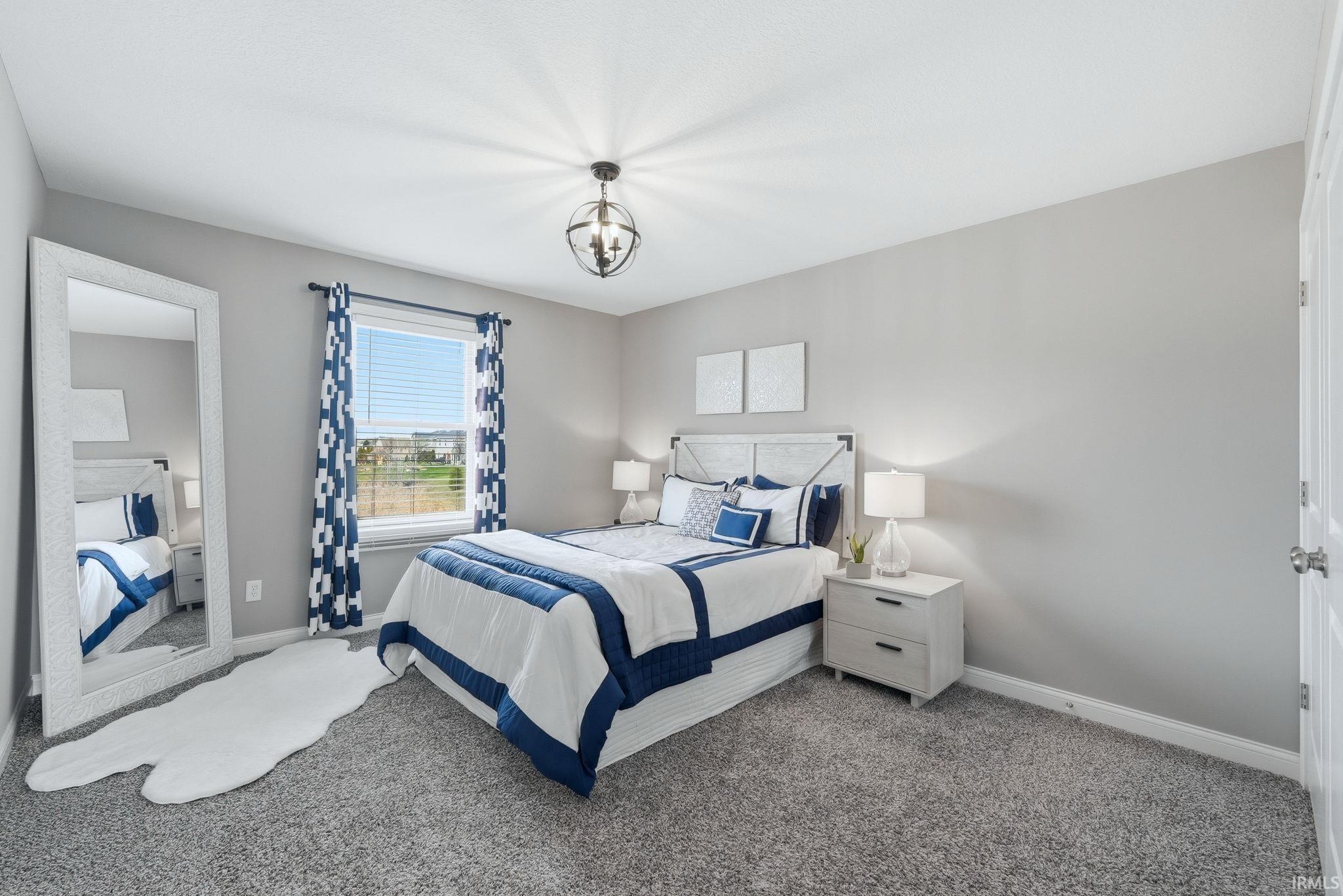 Window with horizontal blinds, overhead spherical light fixture, wall-to-wall carpeting, light gray wall paint, and white trim
