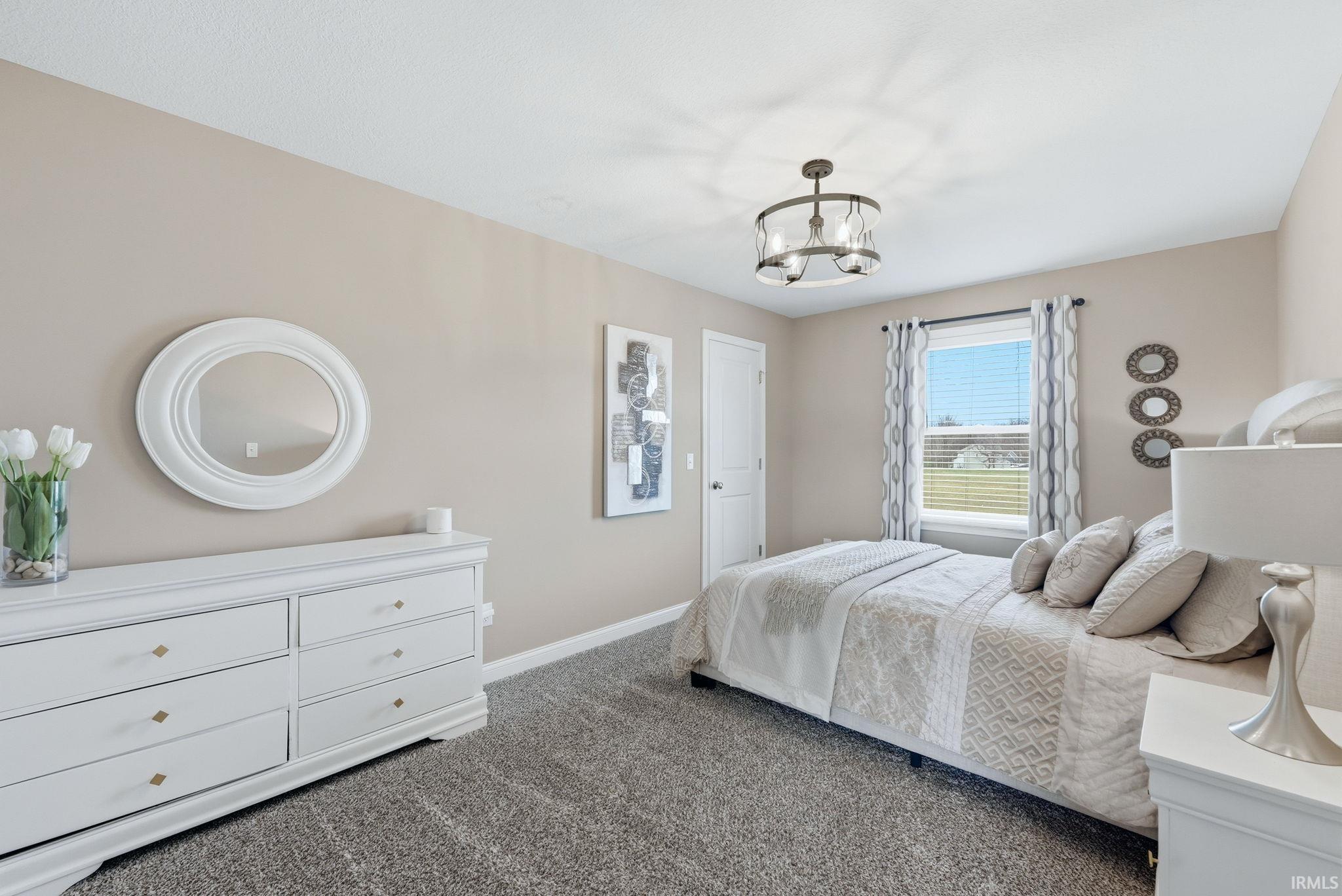 Neutral-toned walls, plush carpet flooring, and a modern ceiling light fixture