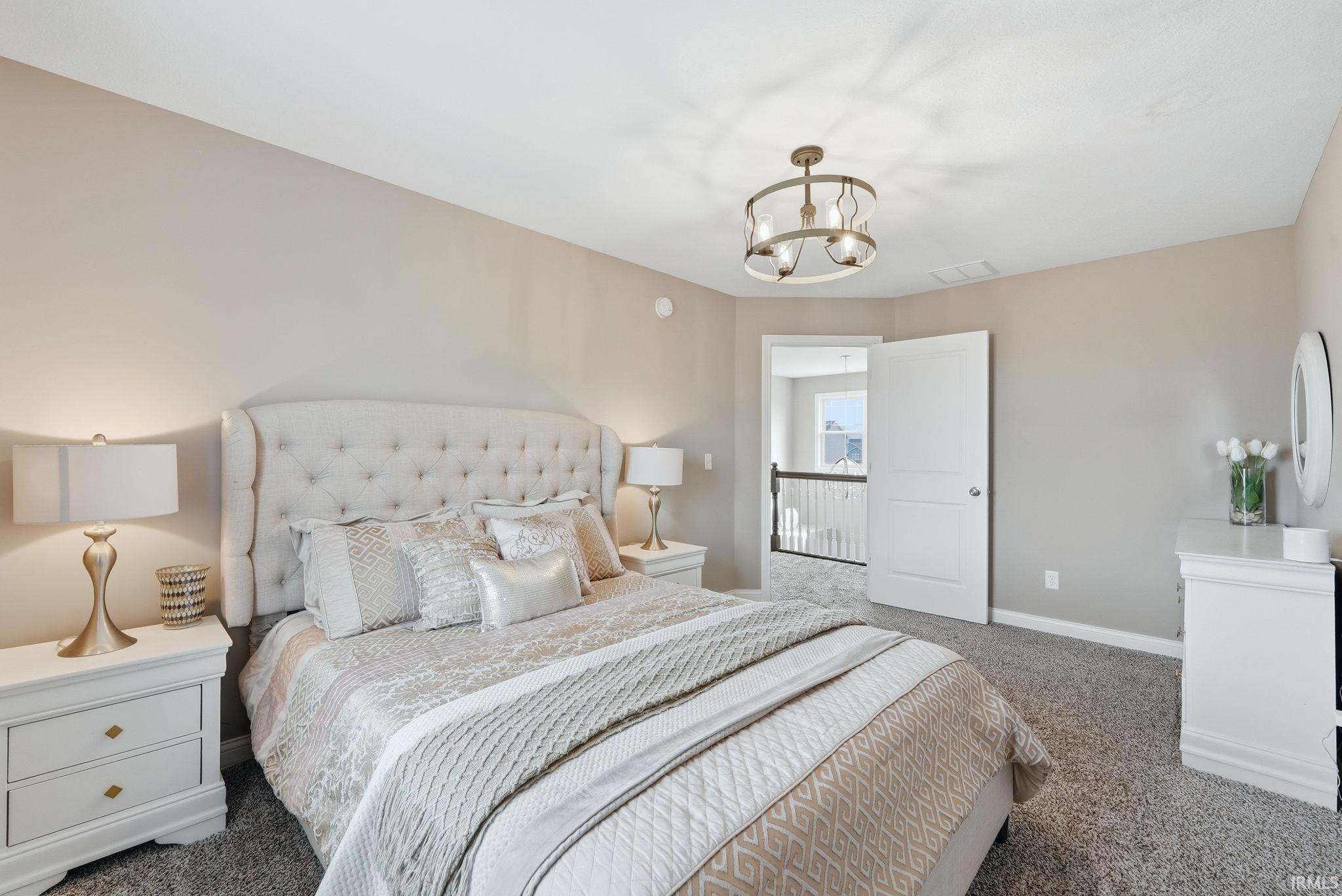 Neutral-toned walls complement the carpeted flooring