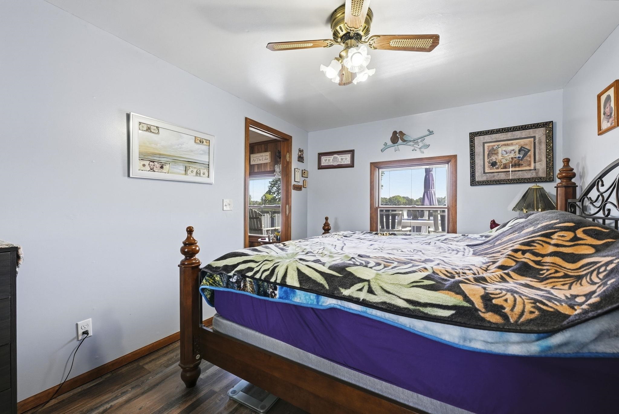 Primary Bedroom with Ceiling Fan and Wood-Finish Flooring