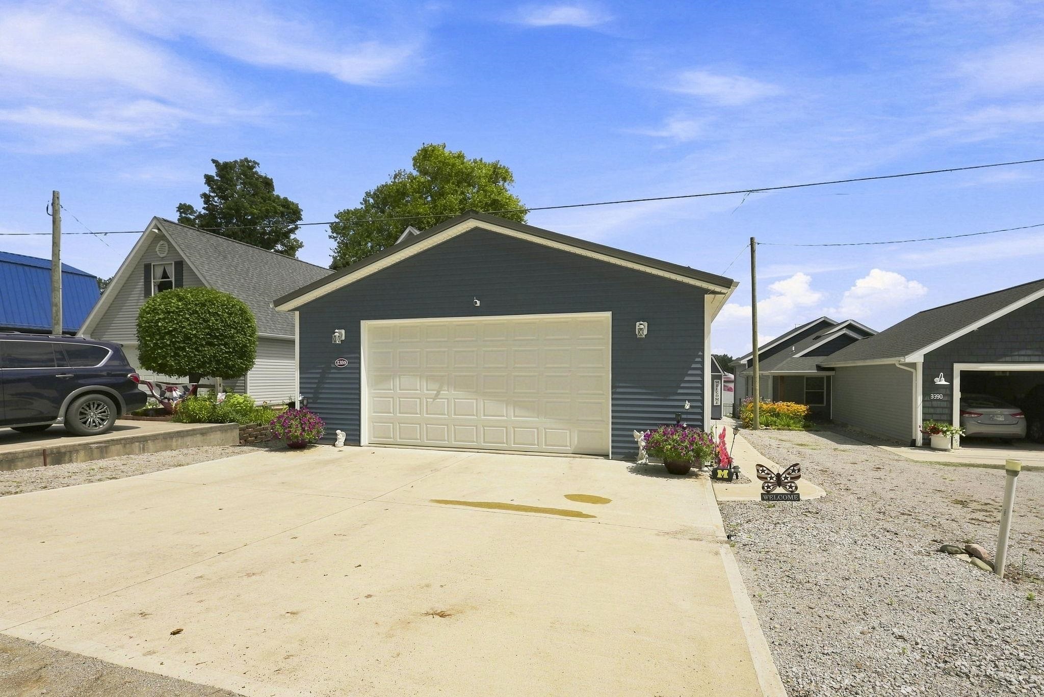 Attached garage with blue siding and white garage door