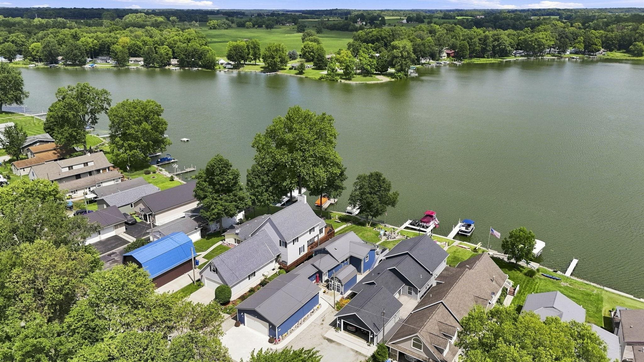 Lakefront properties with private docks, manicured lawns, and mature trees