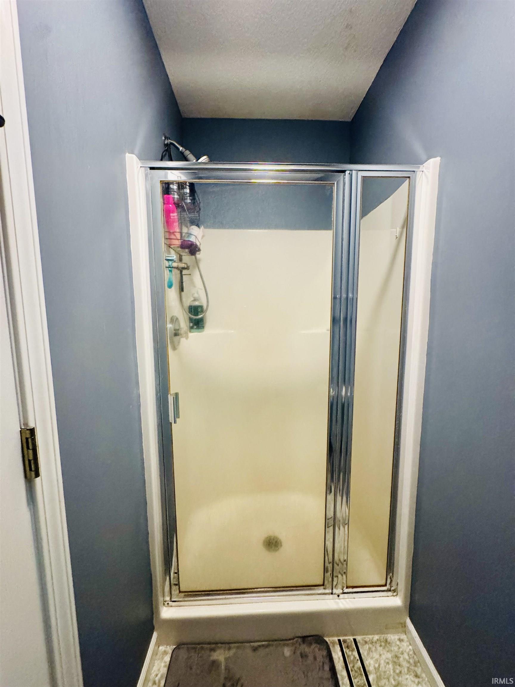 Shower stall with clear glass enclosure and chrome hardware