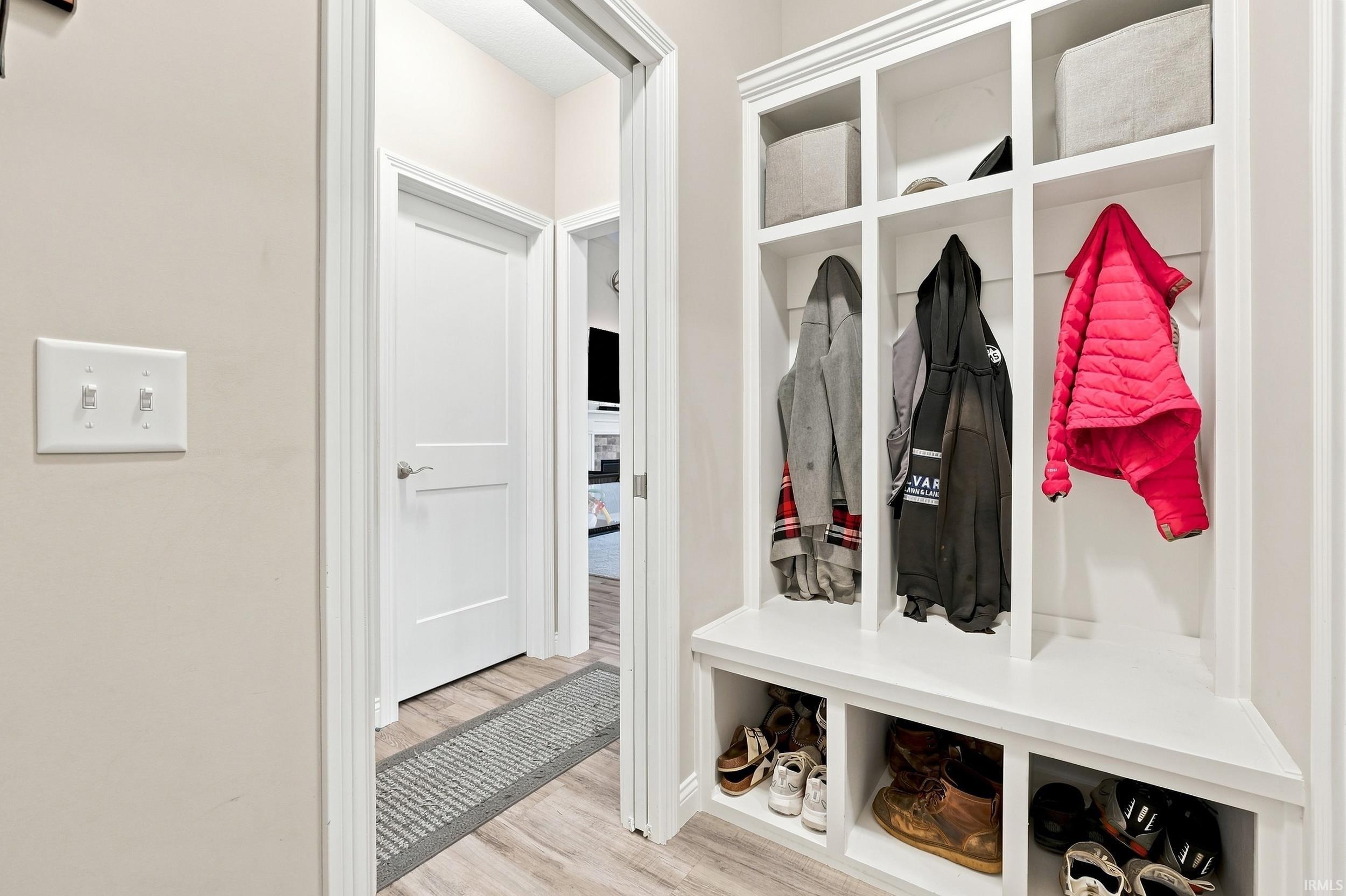 Built-in white storage unit with cubbies and bench seating