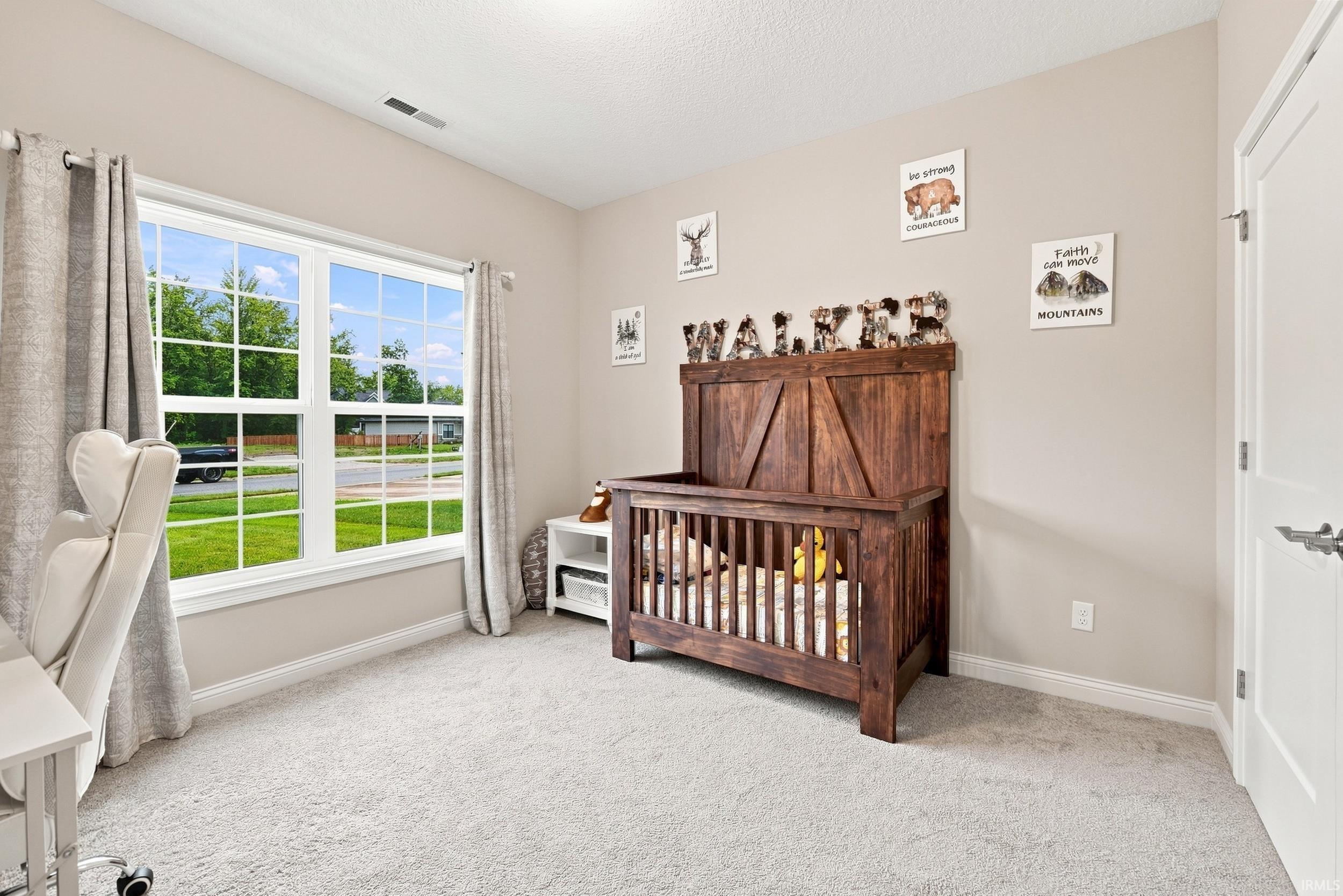 Neutral-toned walls complement plush carpeting