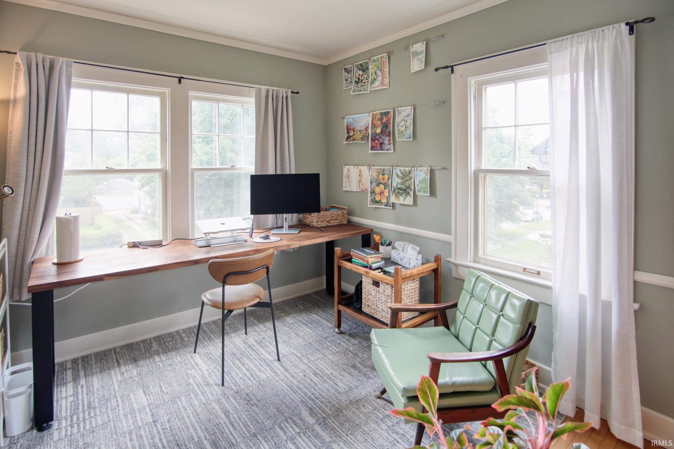 Wood-finish built-in desk with black metal supports, paired with a light gray patterned area rug