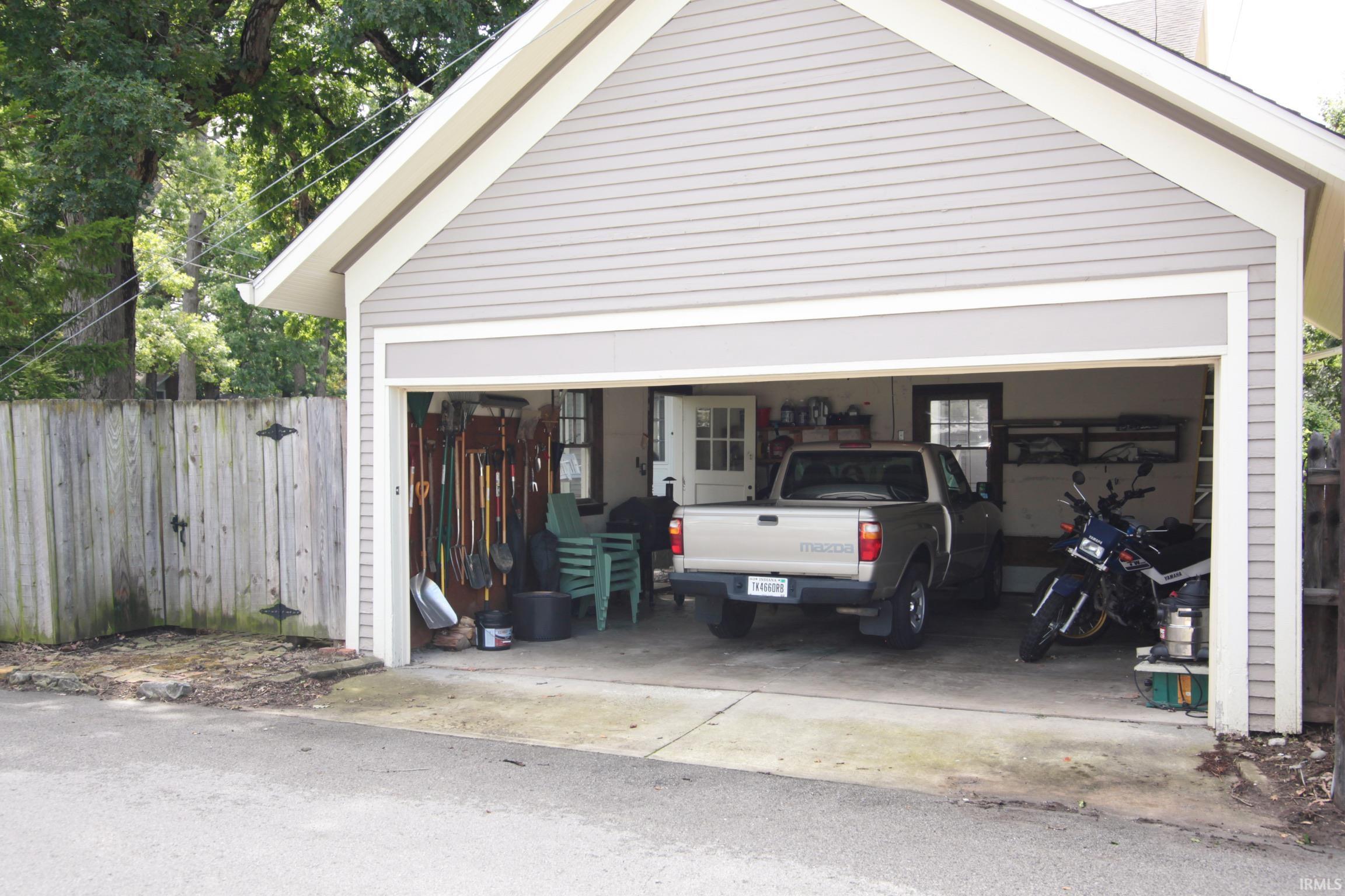 Two-car garage with light gray horizontal siding and white trim