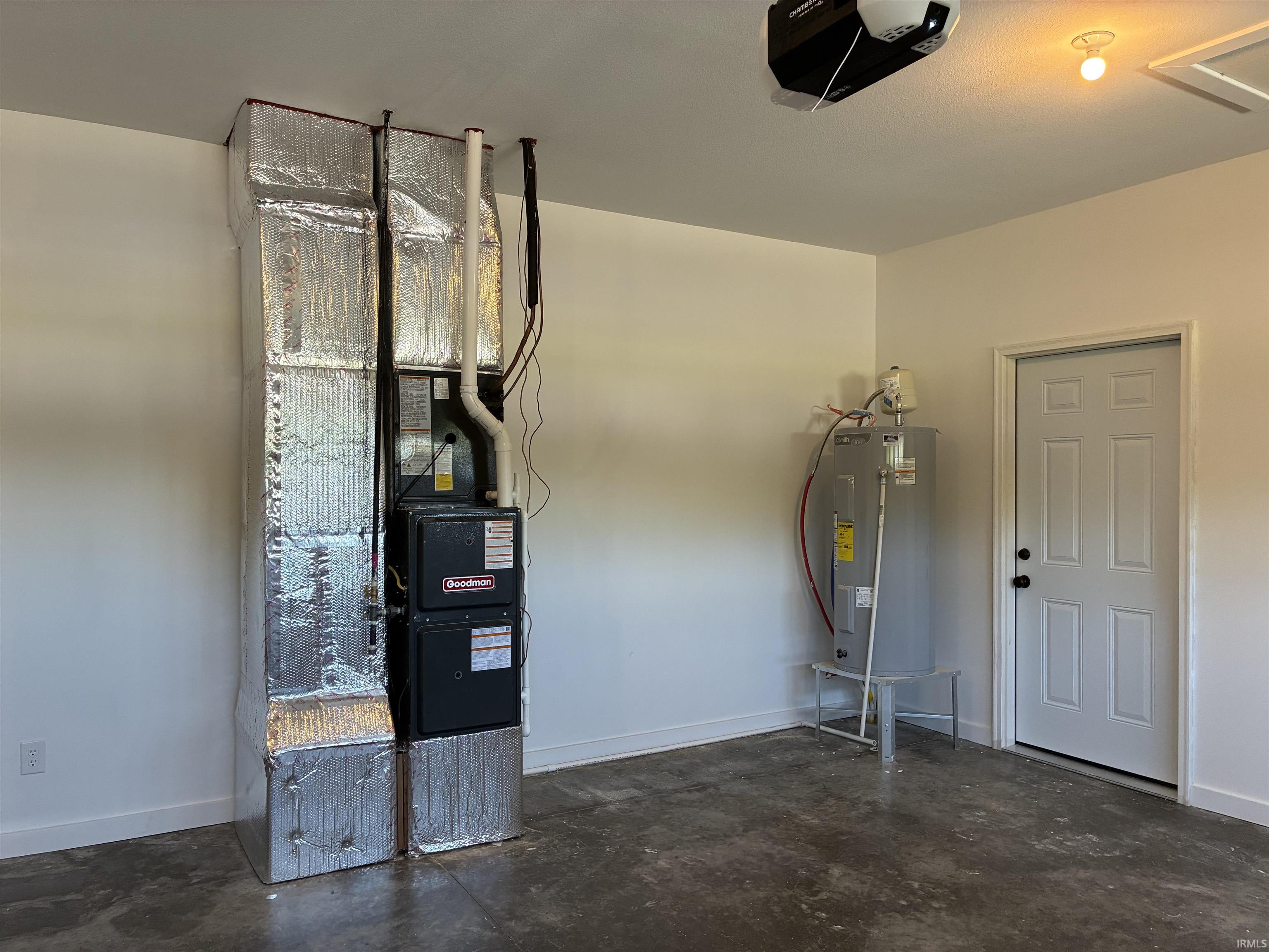HVAC system with insulated ductwork, water heater, and a paneled door