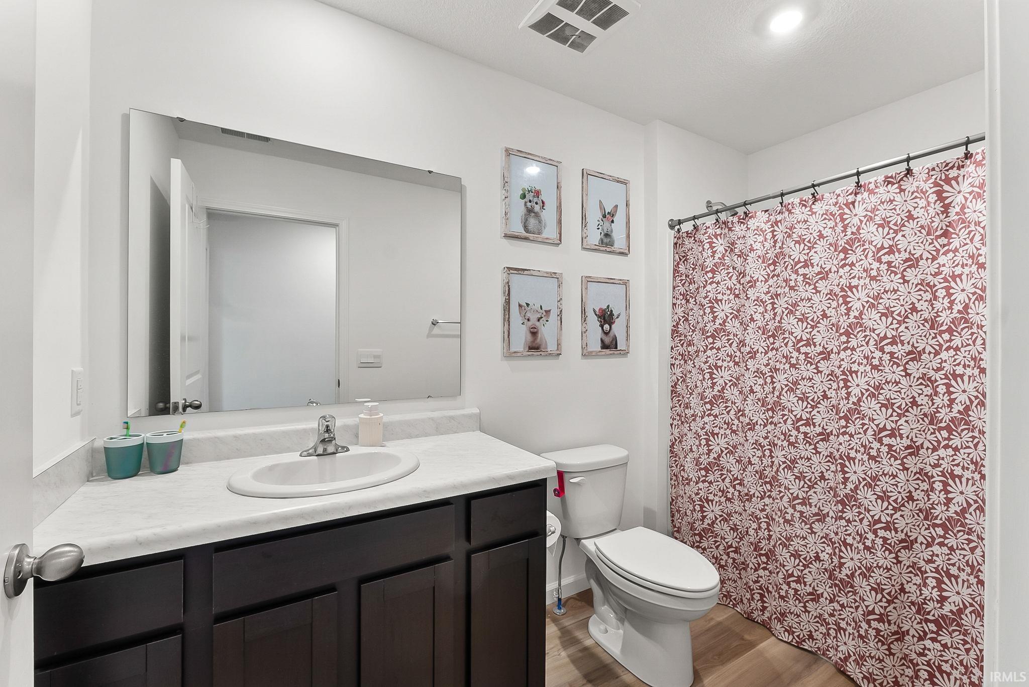 Dark wood-finish vanity with an integrated sink and chrome faucet