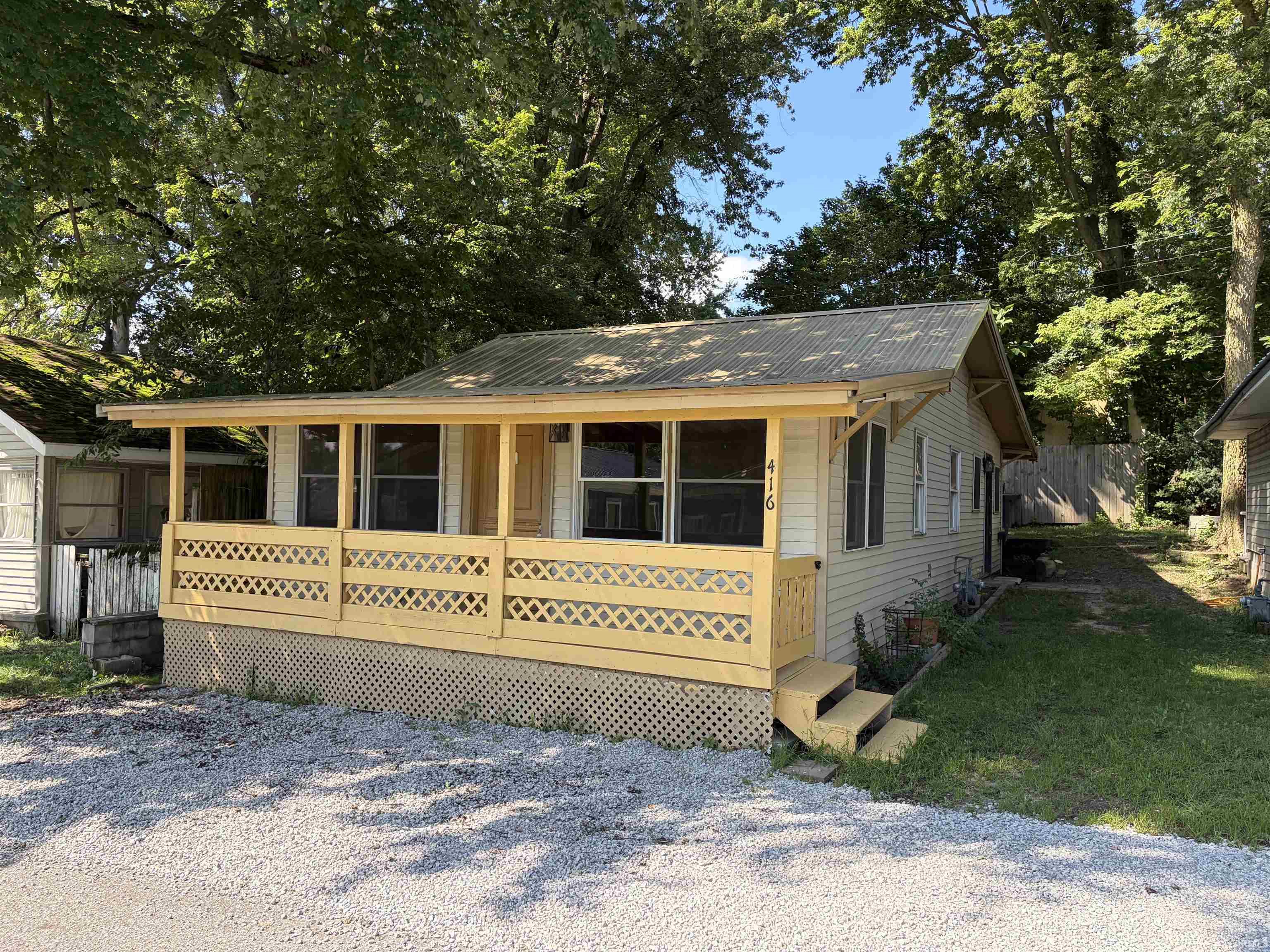 Front porch with lattice railing and entry steps