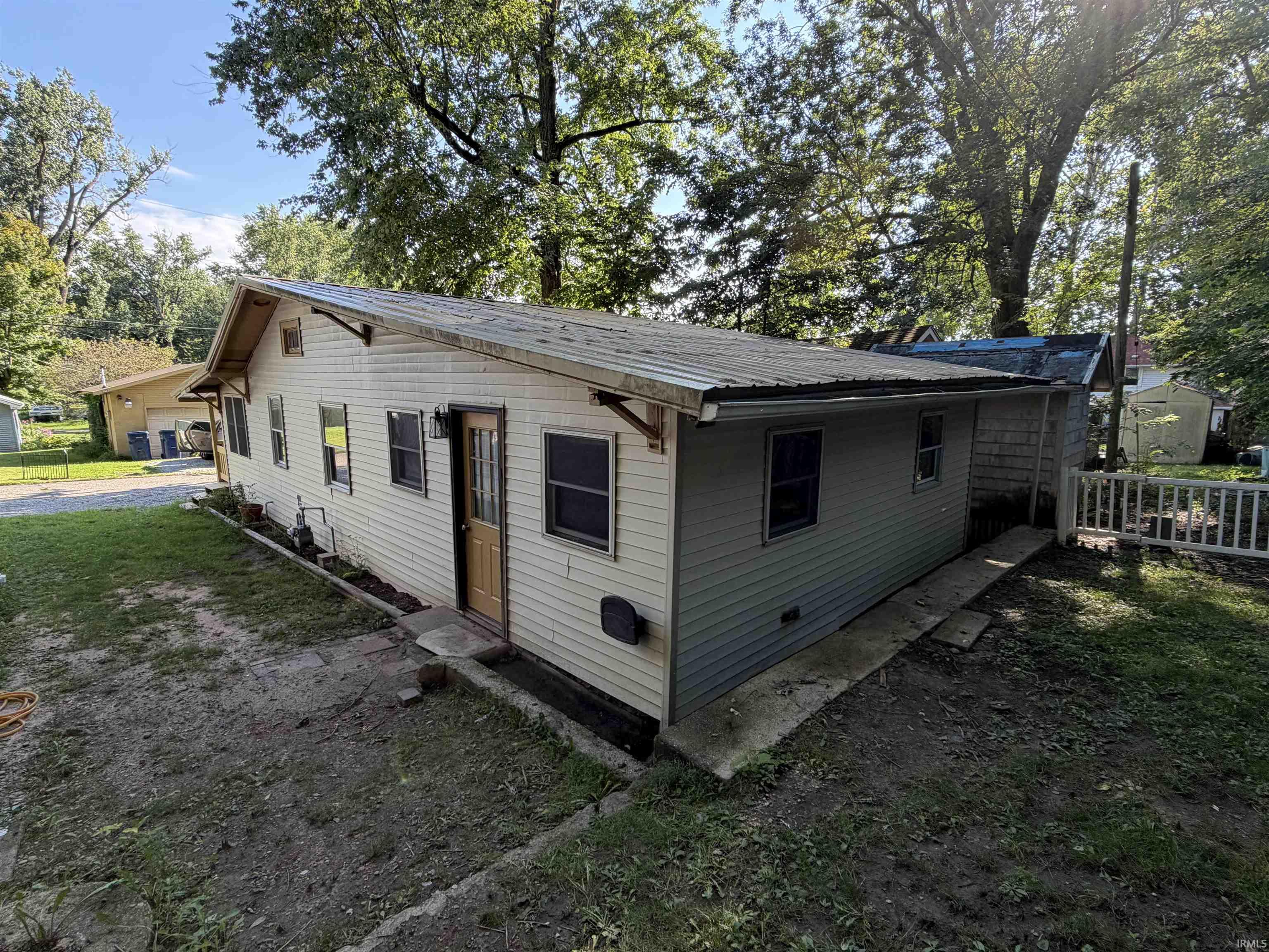 Siding exterior with multiple windows, featuring a light-colored entry door