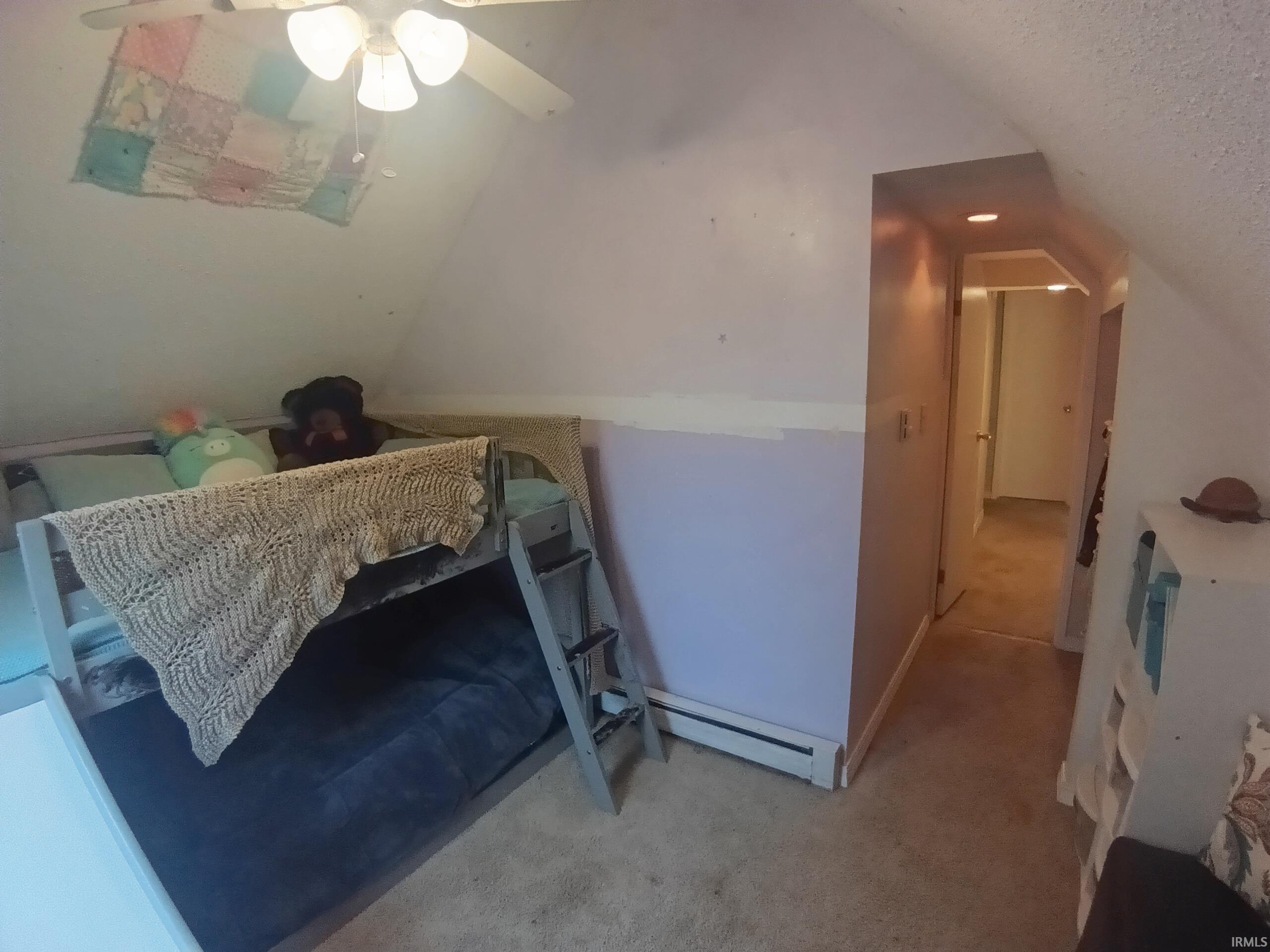 Carpeted flooring, sloped ceiling, and ceiling fan with integrated lighting