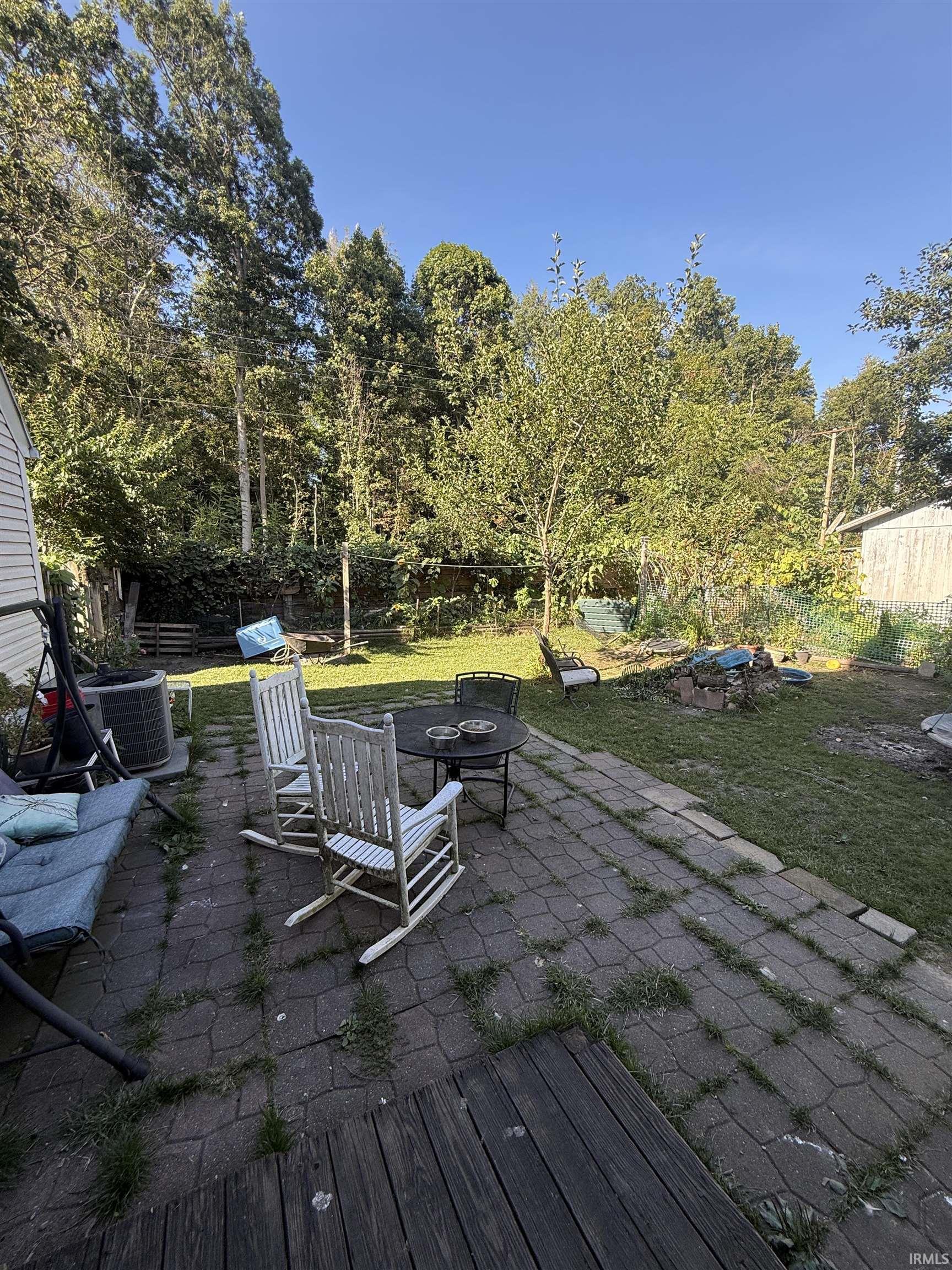 Patio with paver surfacing and wood-finish decking