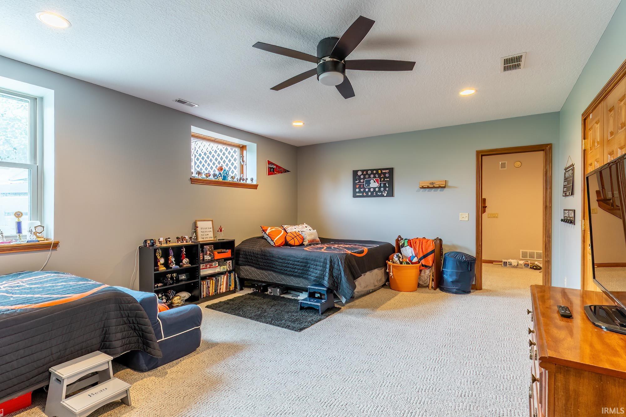 Recessed lighting, ceiling fan, and carpeted flooring