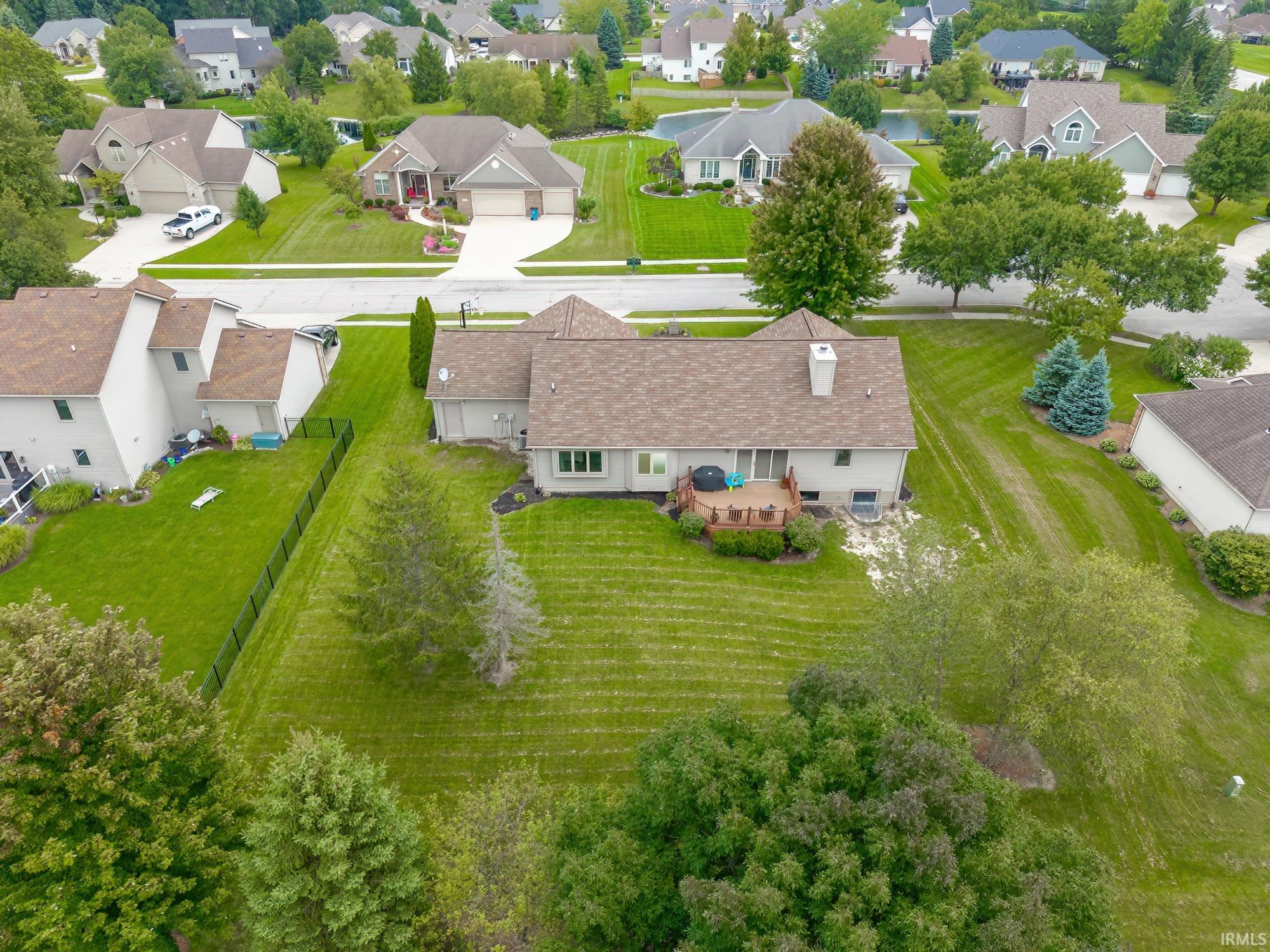 Rear exterior featuring a wood deck, chimney, and a walk-out basement