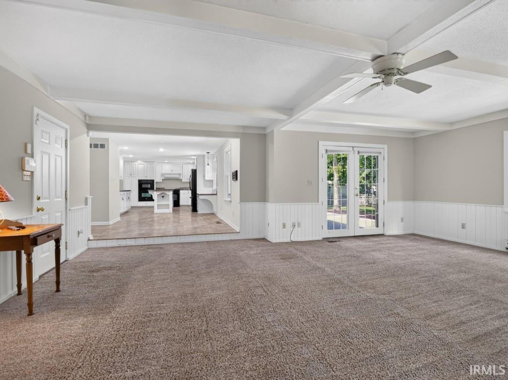 Recessed lighting and ceiling fan complement the exposed ceiling beams