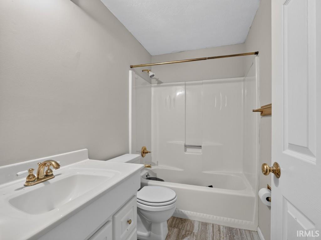 White vanity with integrated sink, gold-finish faucet, and coordinating hardware