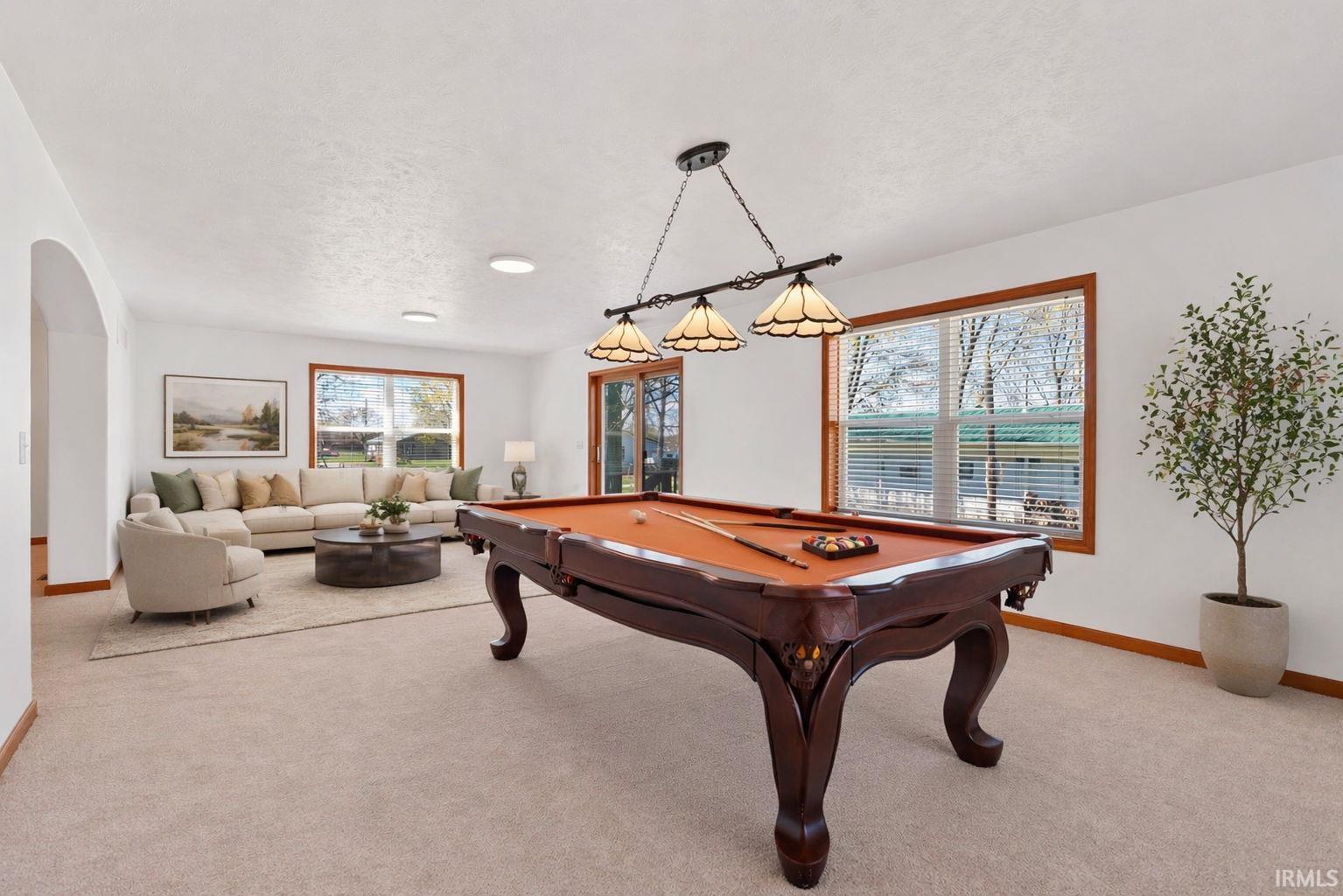 Spacious room featuring neutral carpeting and white walls