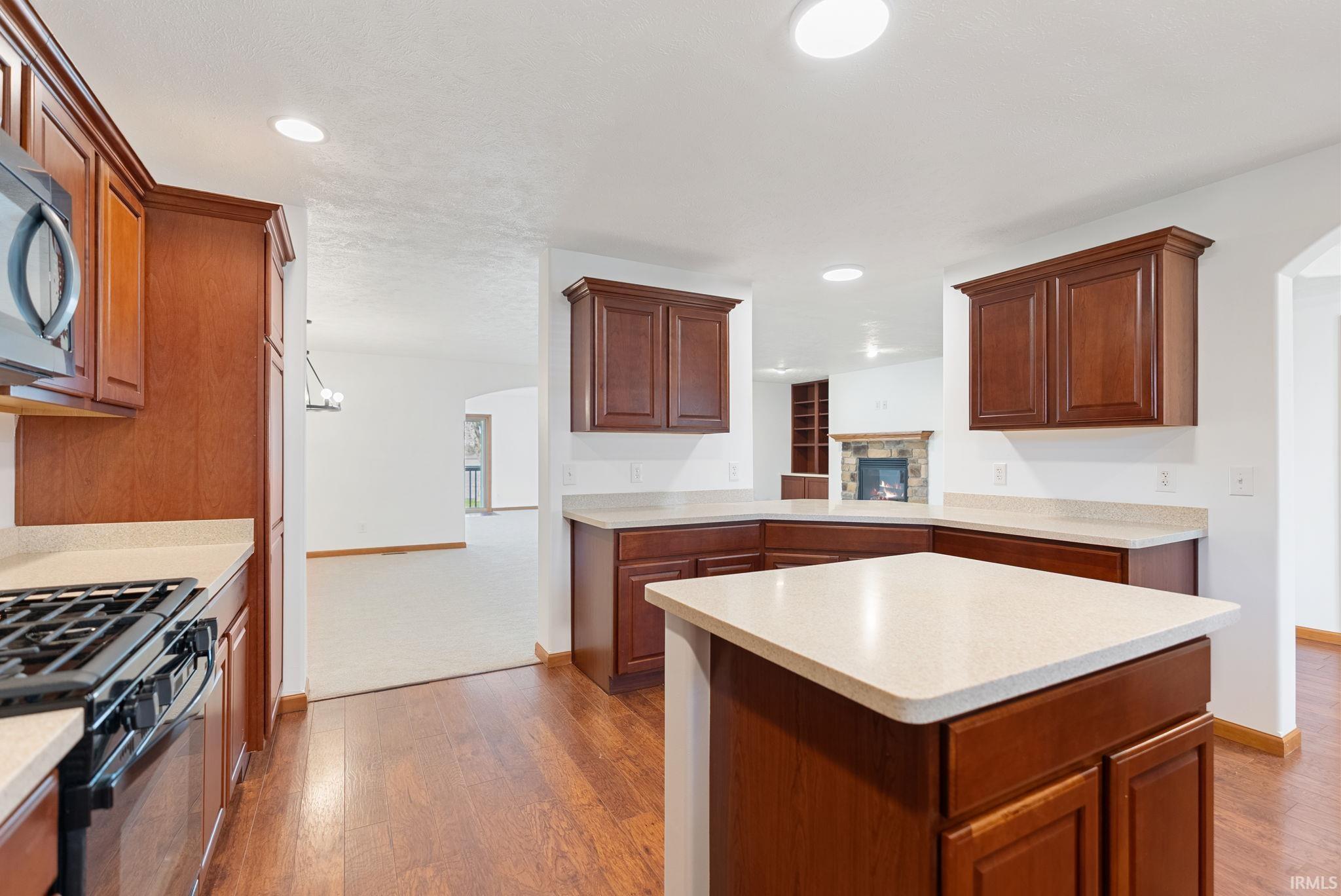 Kitchen featuring wood-finish flooring, recessed lighting, and a gas range