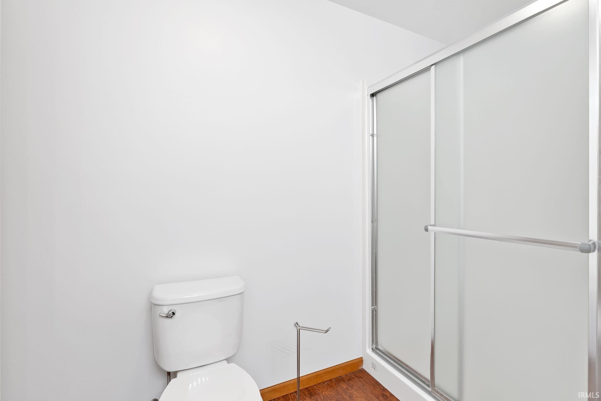 Chrome-framed shower enclosure with frosted glass panels and a white base