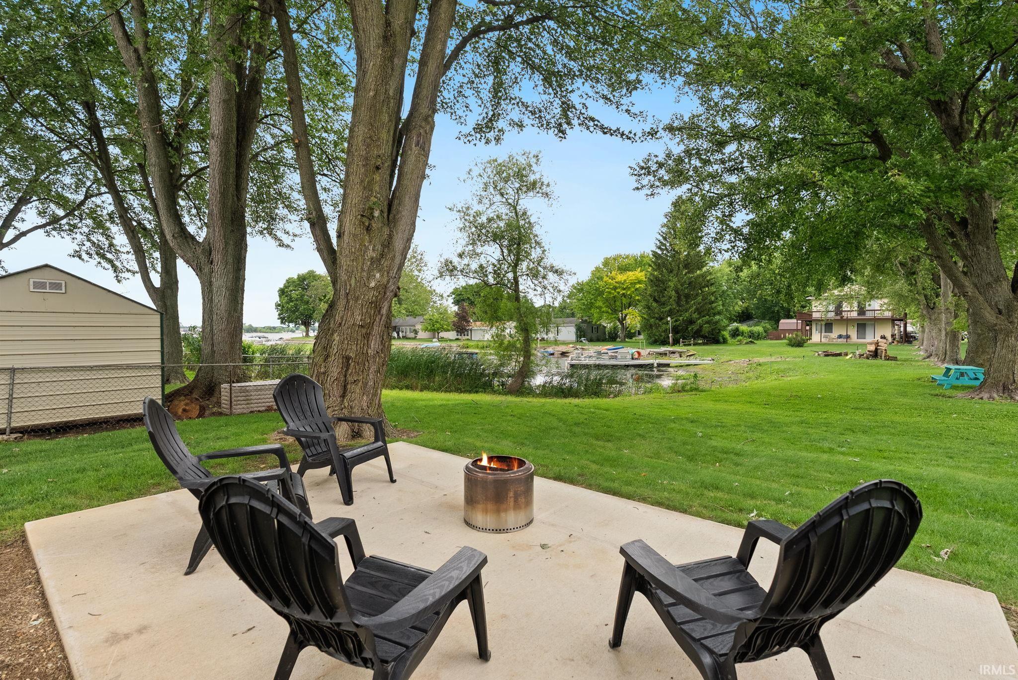 Concrete patio area featuring a metal fire pit