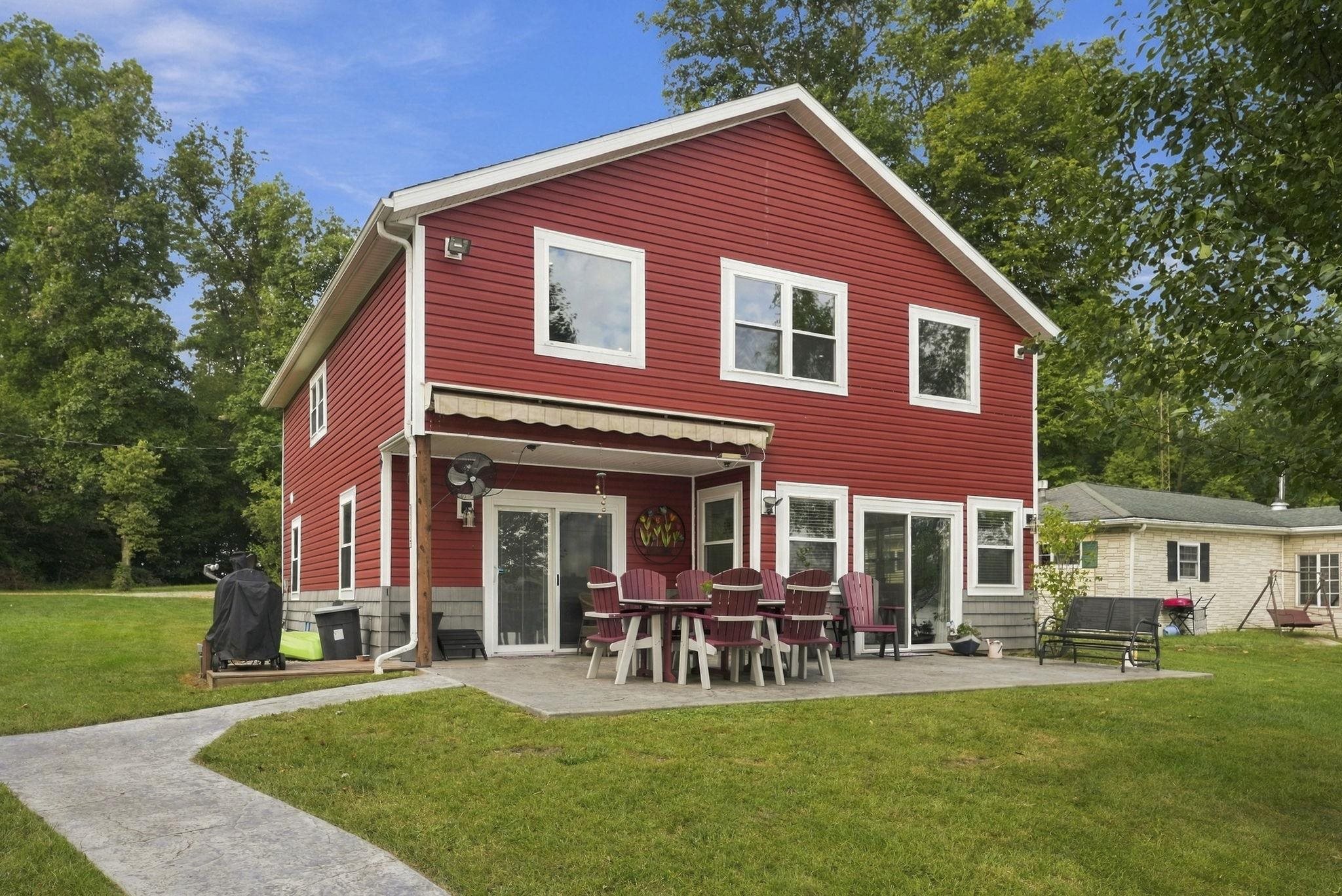 Red siding exterior with white trim windows and a white gable roof