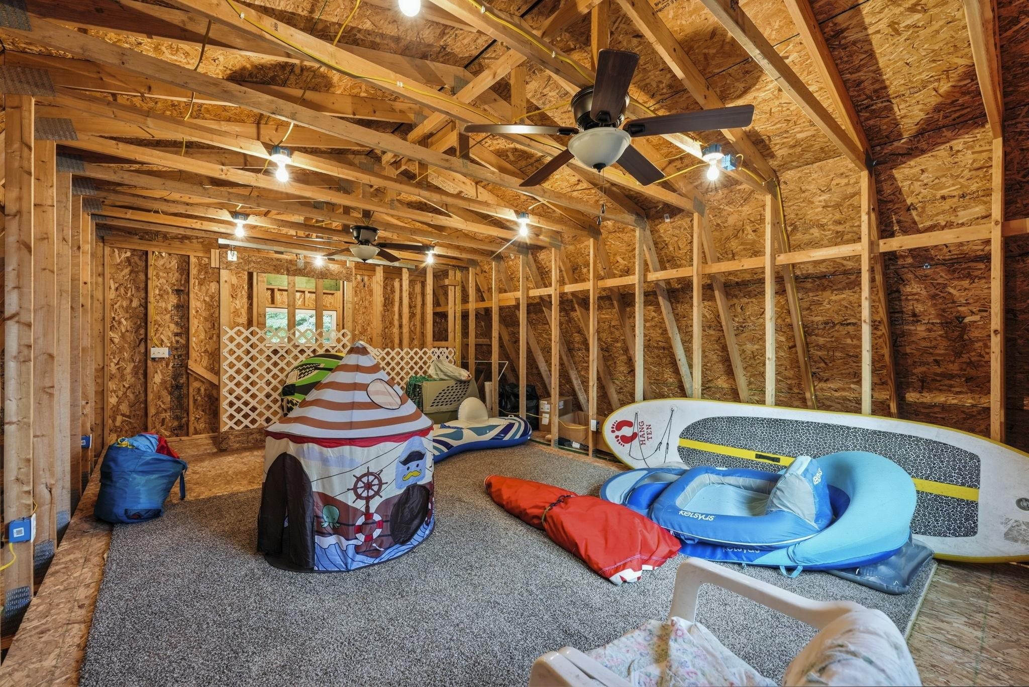 Exposed wood beam ceiling with recessed lighting and ceiling fans