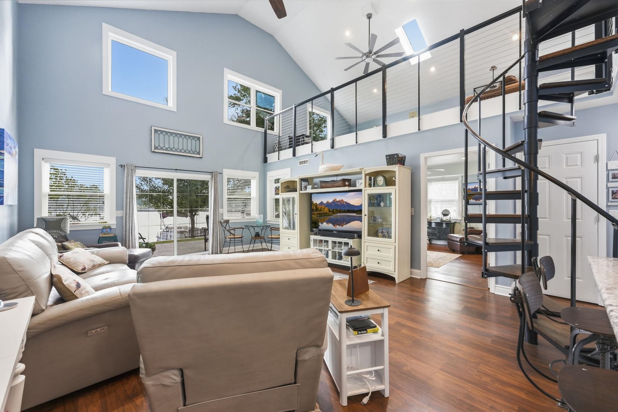 Soaring vaulted ceilings, wood-finish flooring, and an open loft area
