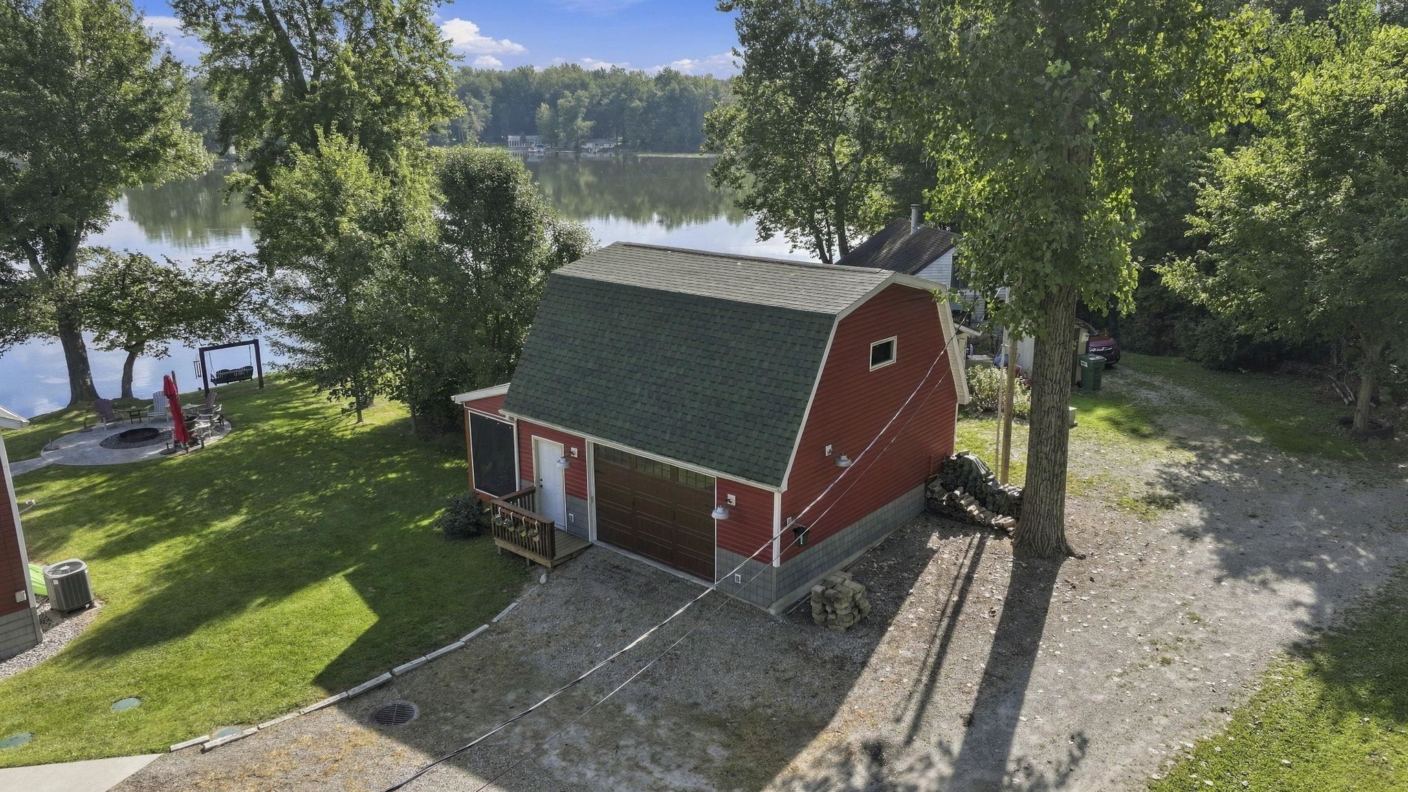 Red gambrel-style structure with a green shingle roof