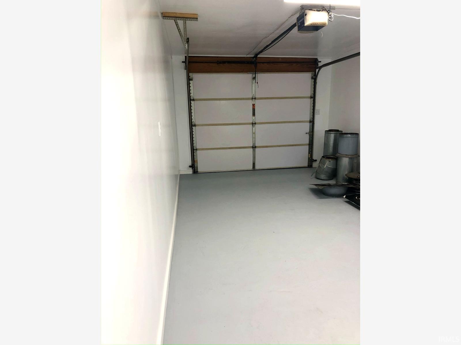 Garage space featuring an overhead door and light-toned flooring