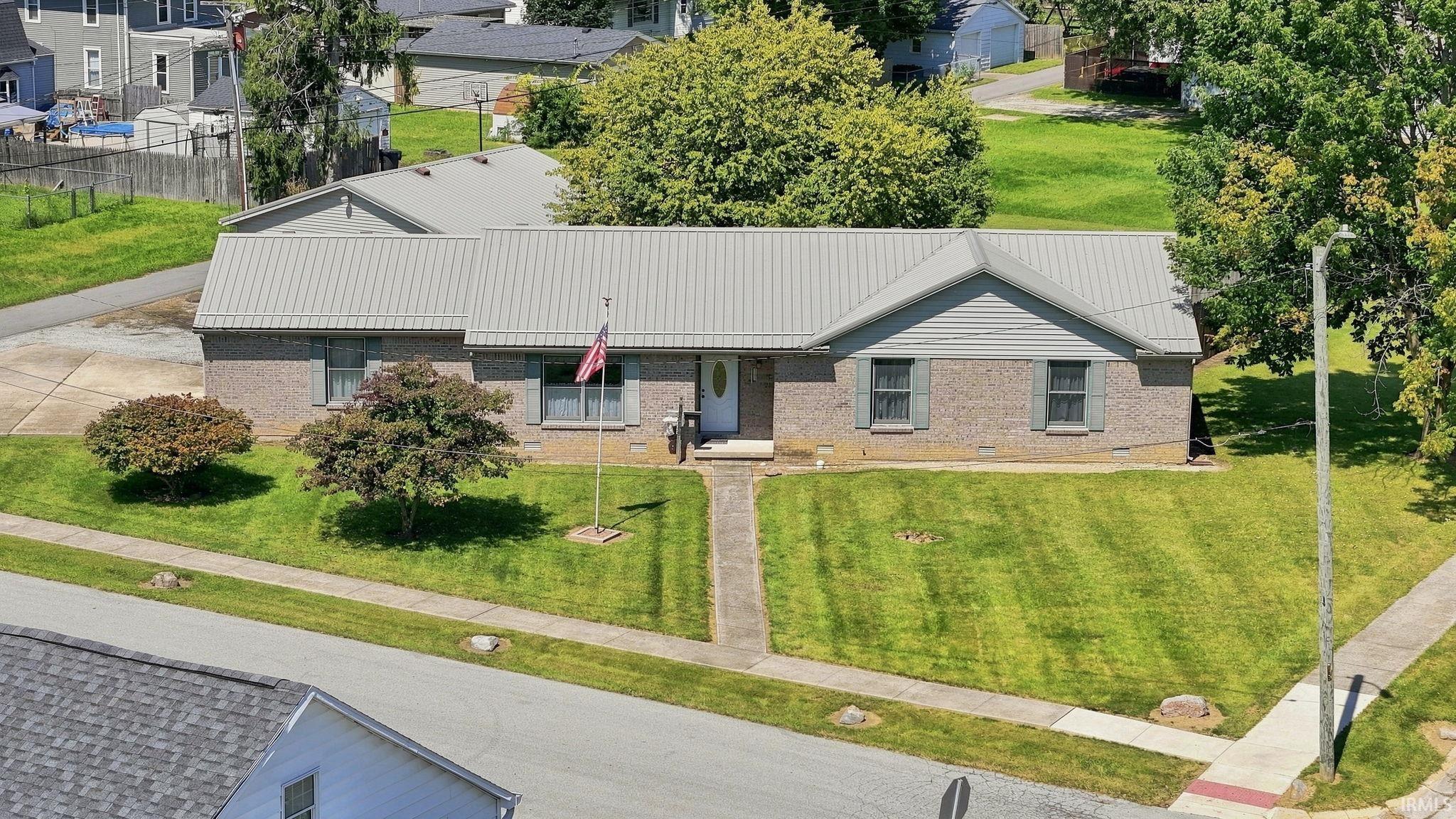 Brick exterior with a light gray metal roof