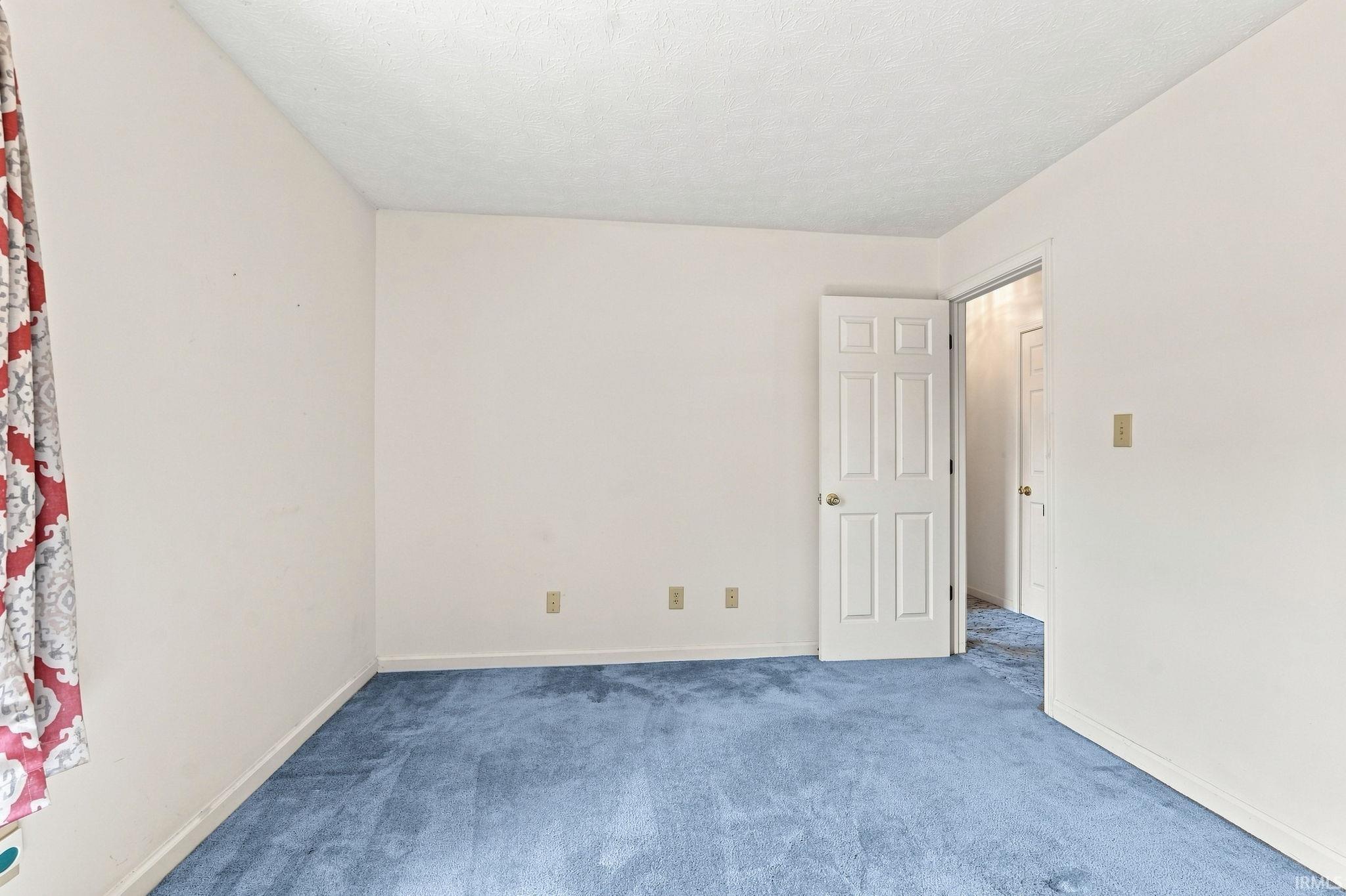 Wall-to-wall carpeting and white painted walls