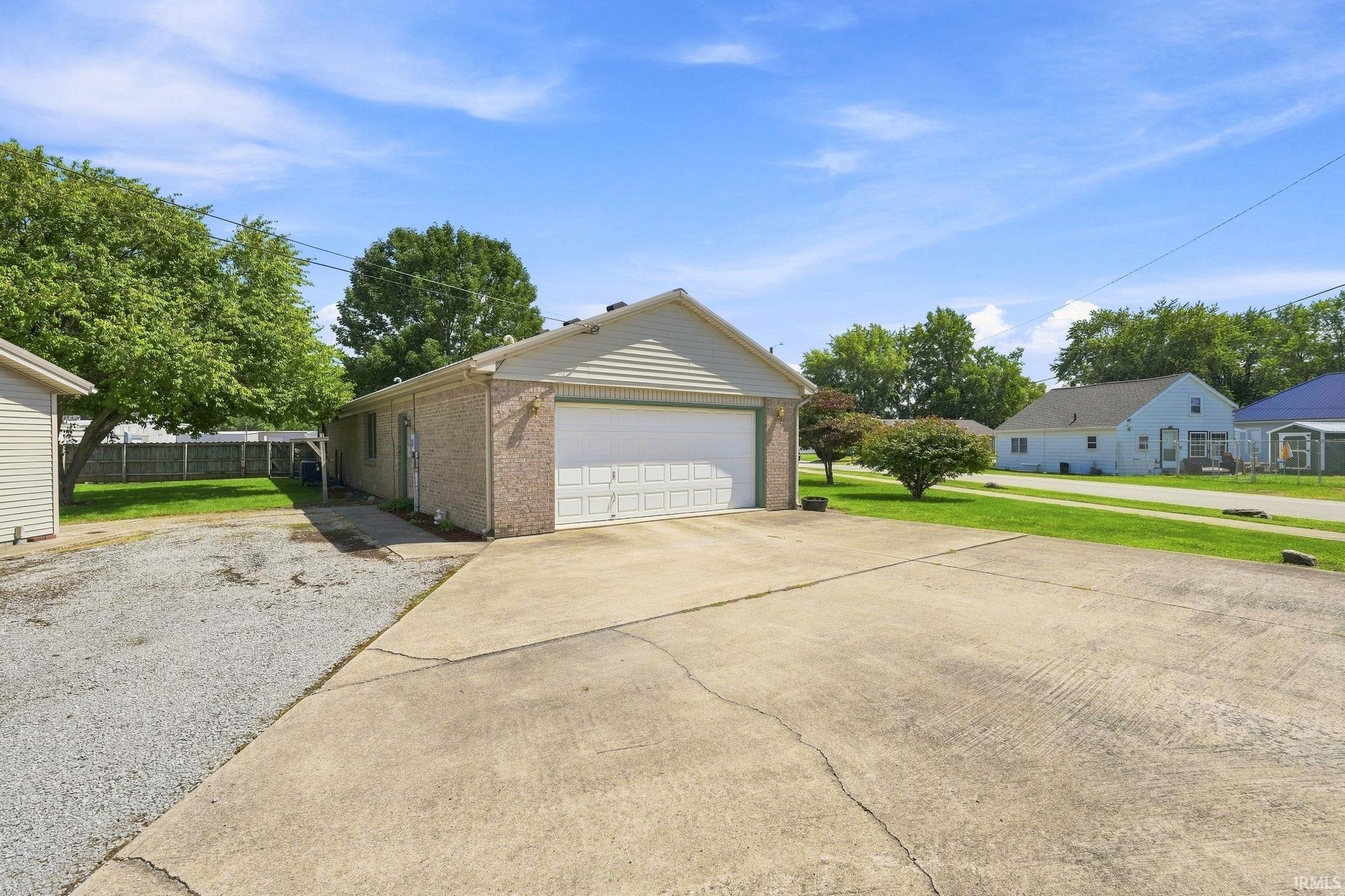 Attached two-car garage with a concrete driveway