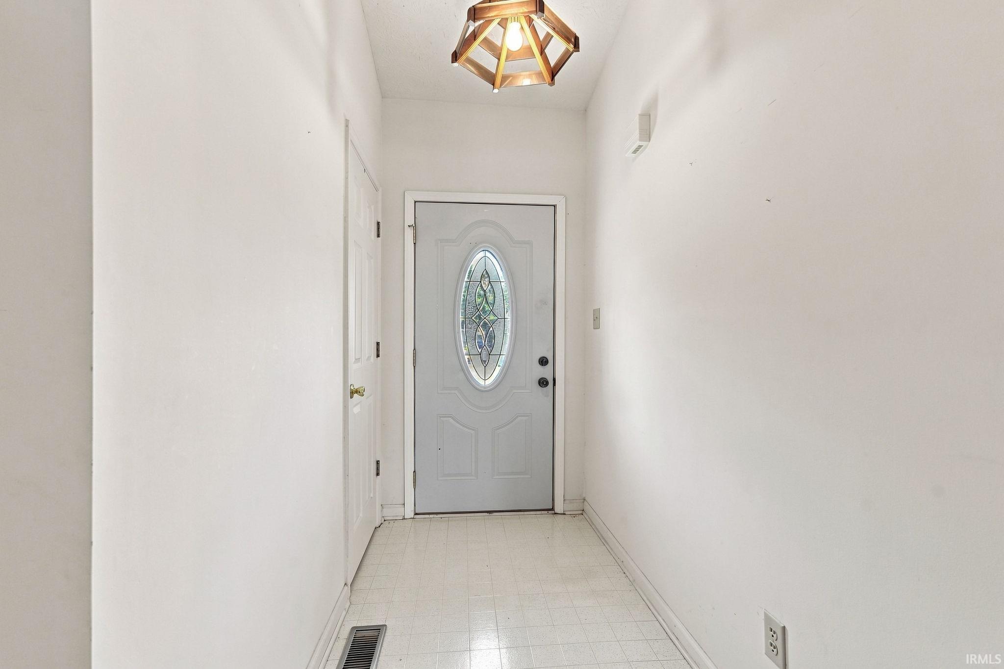 White entry door with decorative oval glass insert