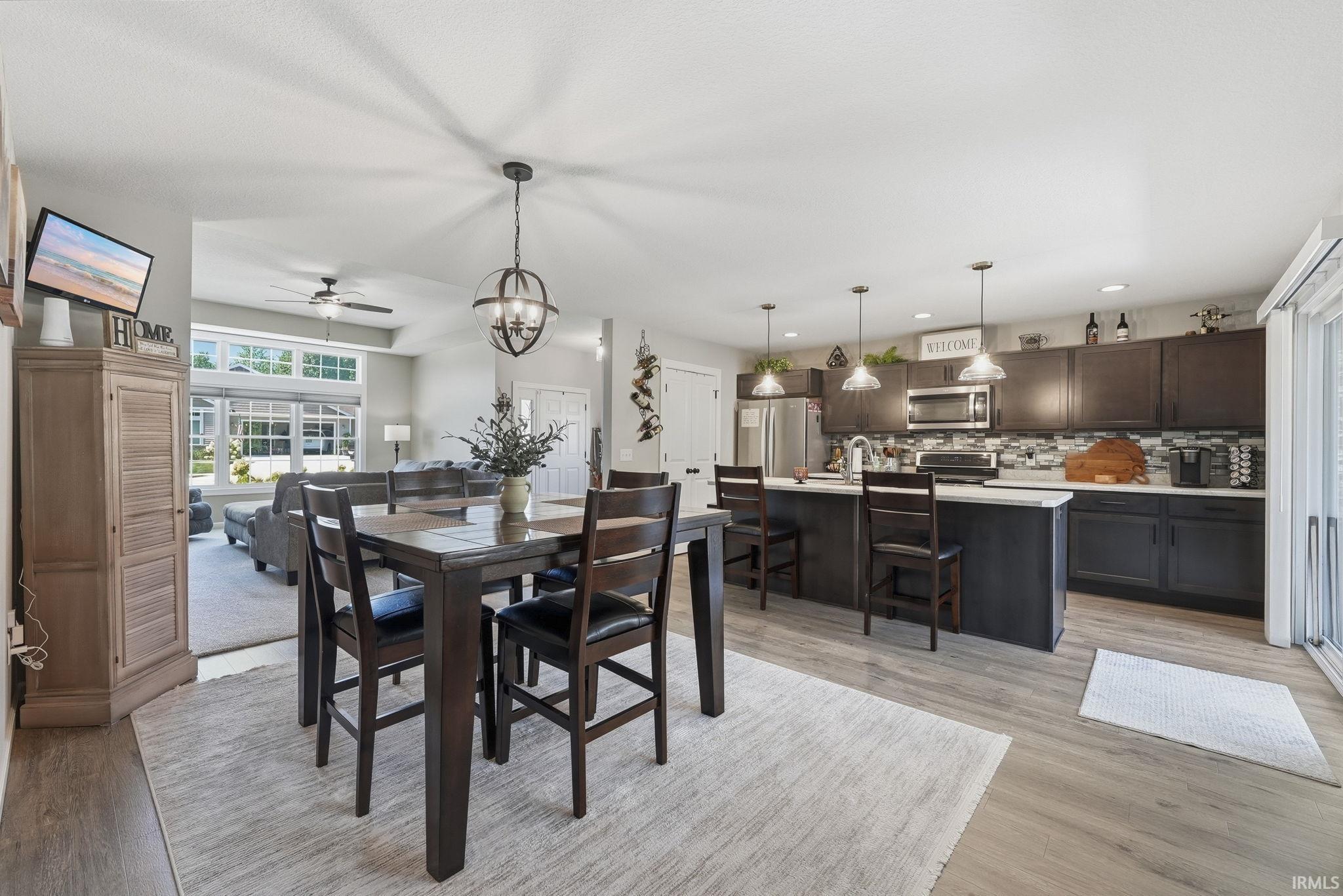 Open-concept living space with wood-finish flooring
