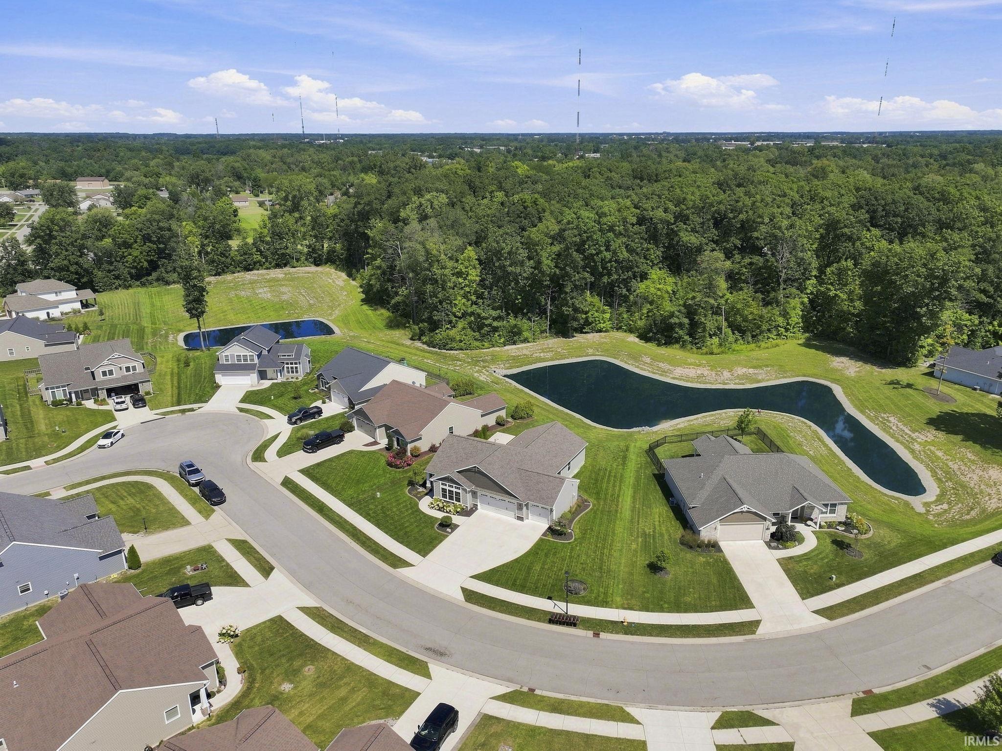 Residential neighborhood featuring paved streets, landscaped yards, and two ponds