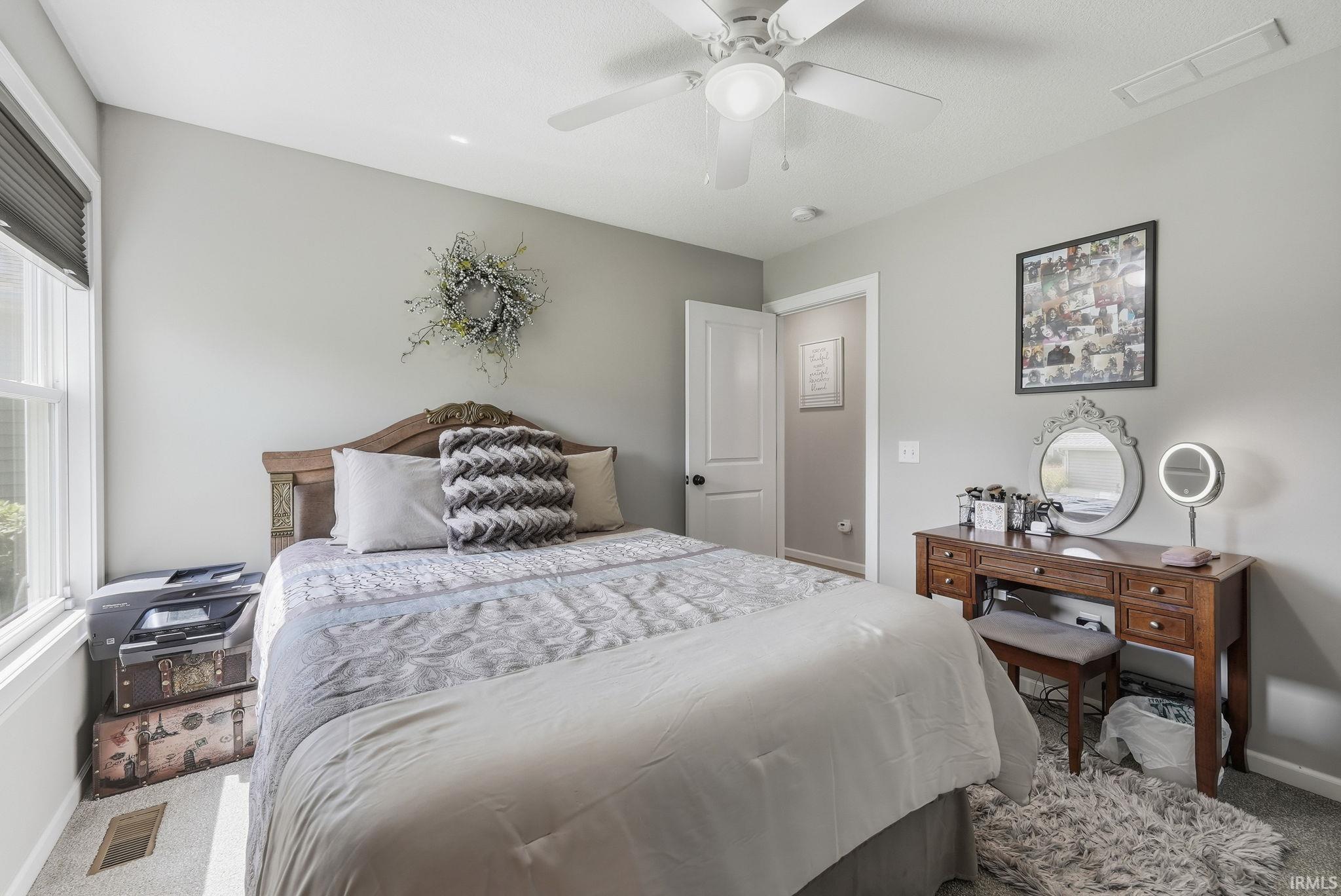 Carpeted room with a ceiling fan, recessed lighting, and a window with blinds
