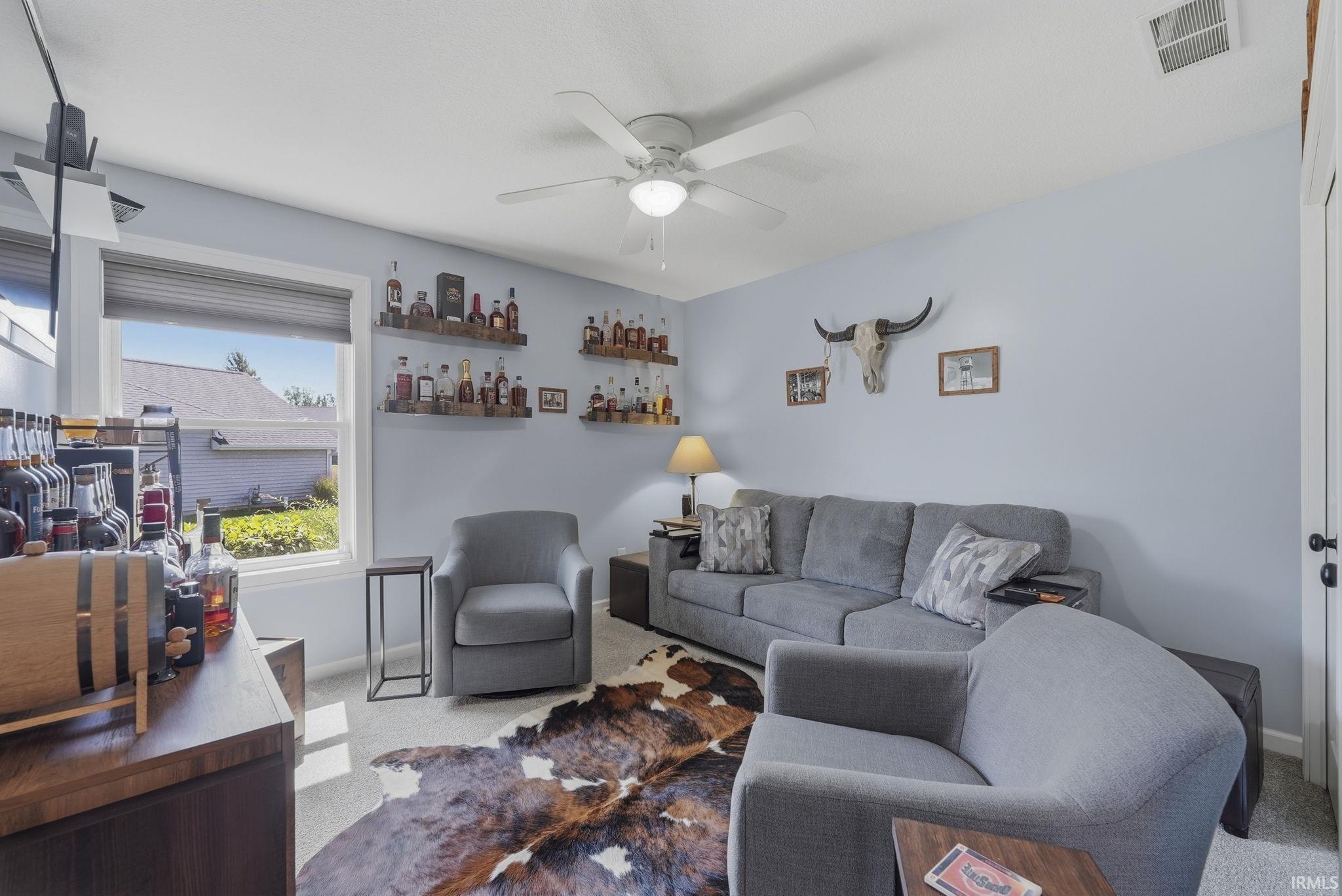 Light blue walls, white trim, and a ceiling fan with integrated lighting