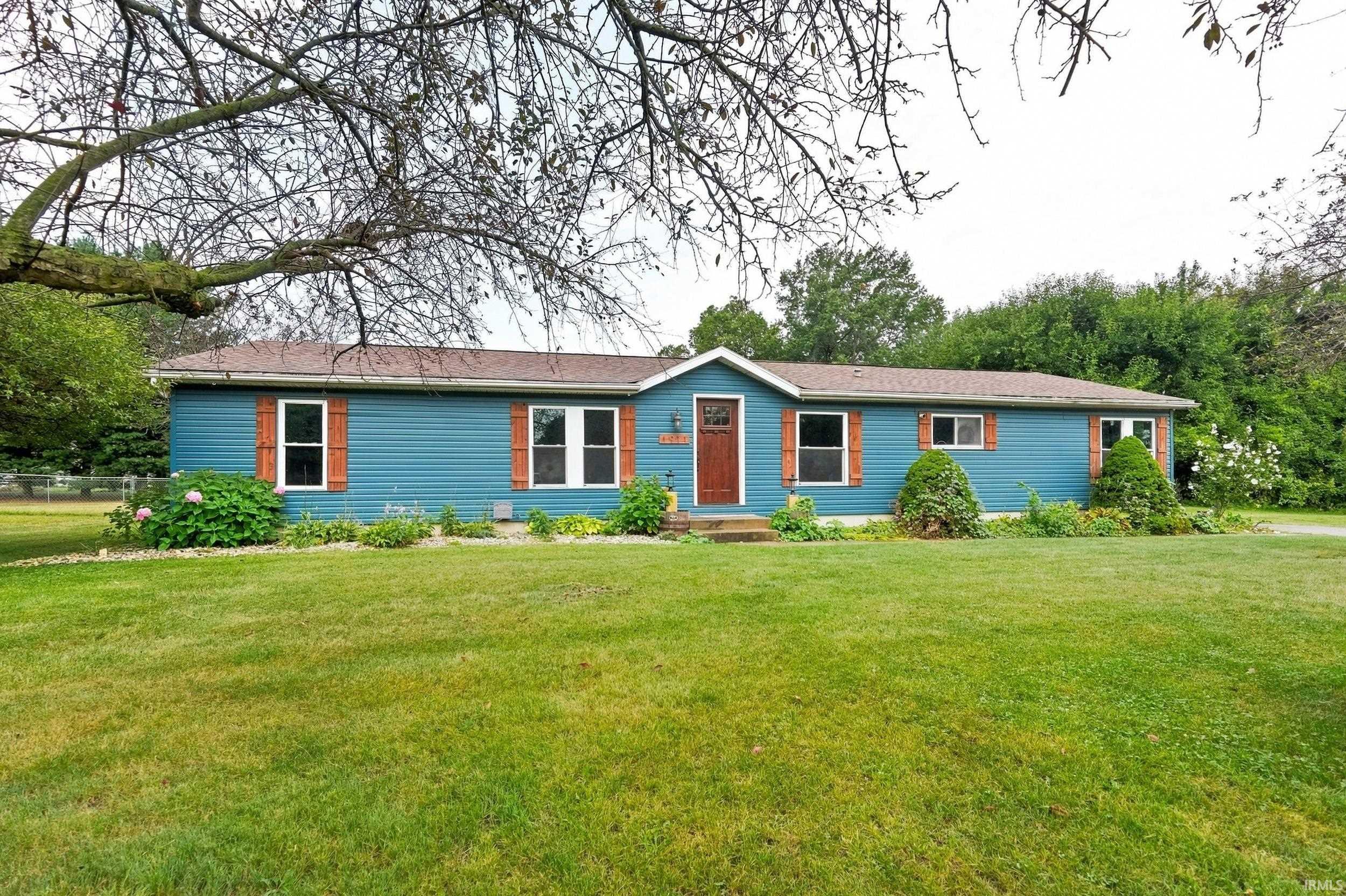 Blue siding exterior with a brown shingle roof