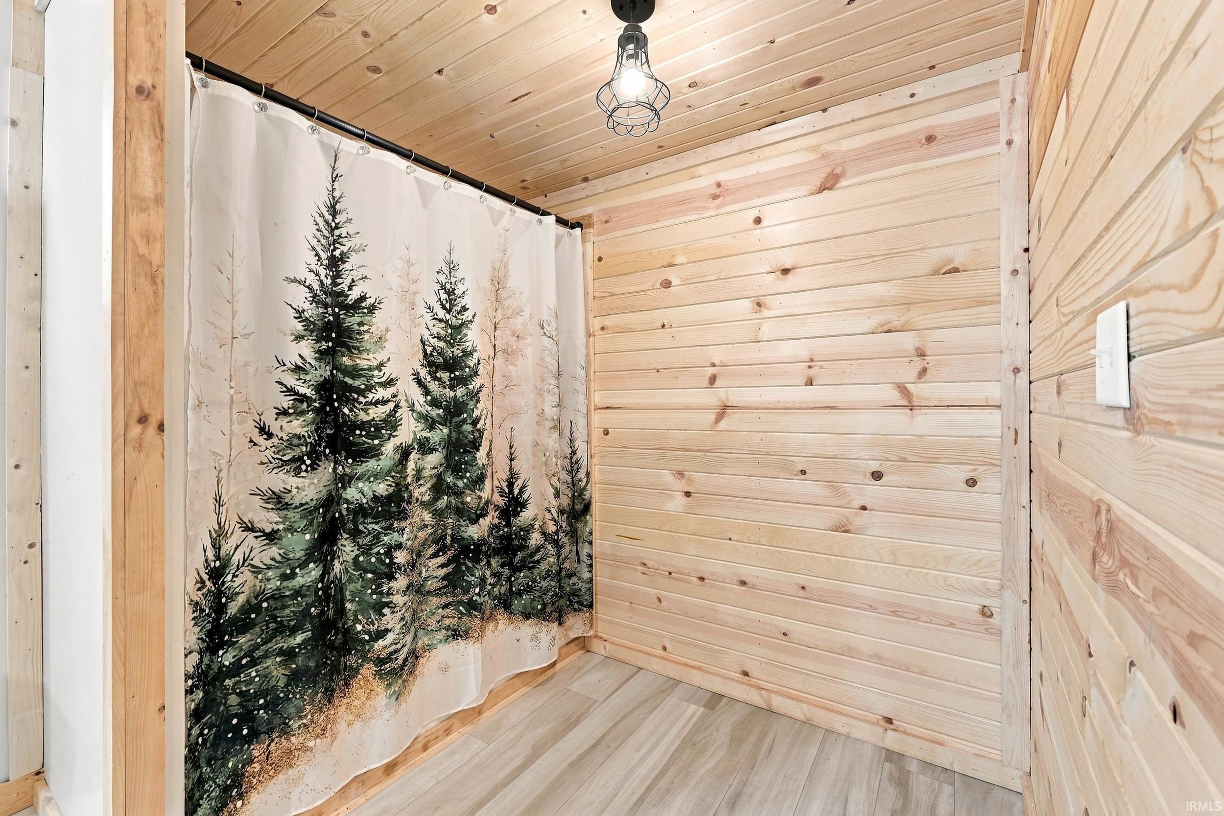 Wood-paneled walls and ceiling with a light wood-finish flooring