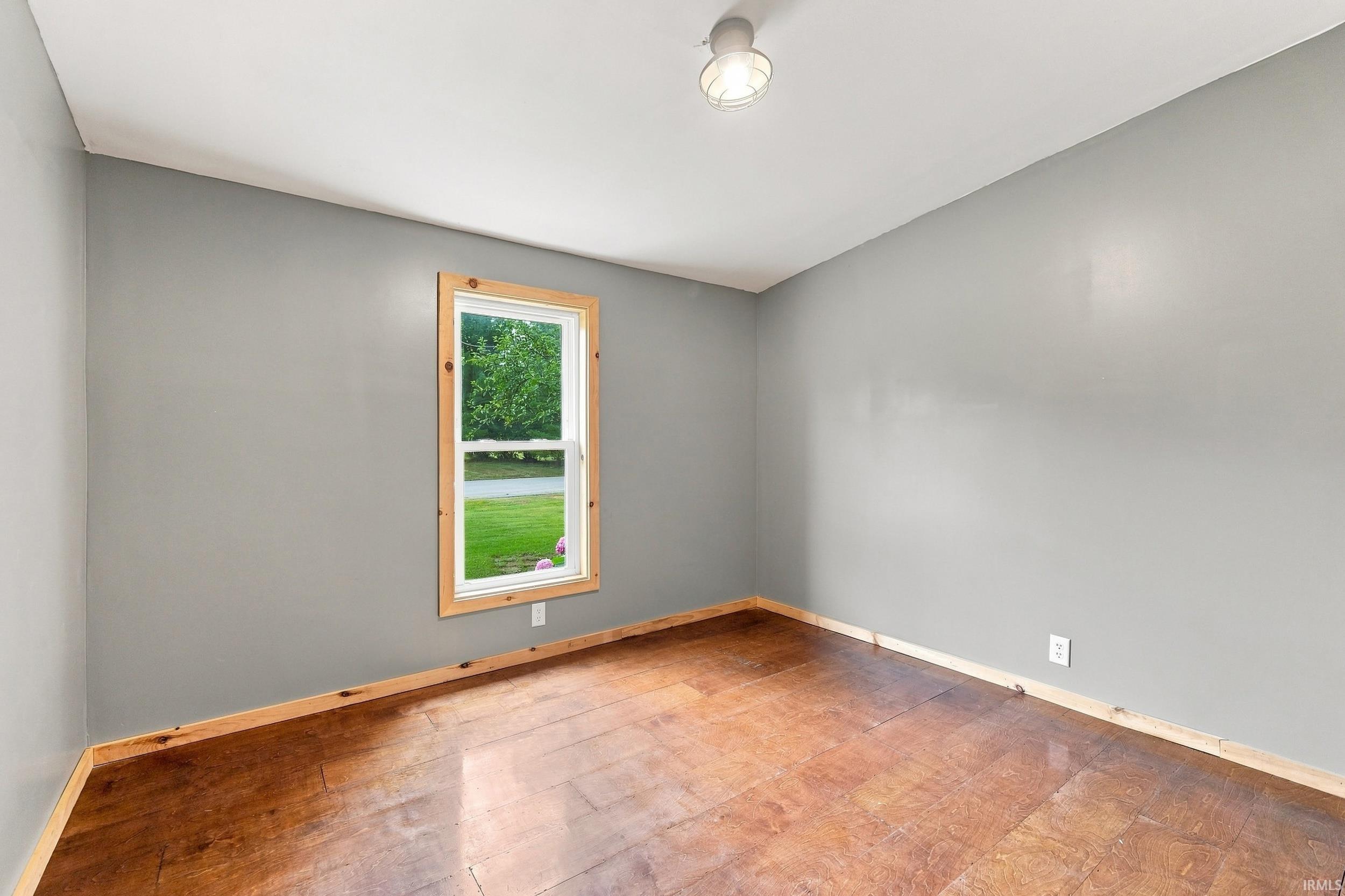 Gray painted walls with natural wood-finish flooring and trim