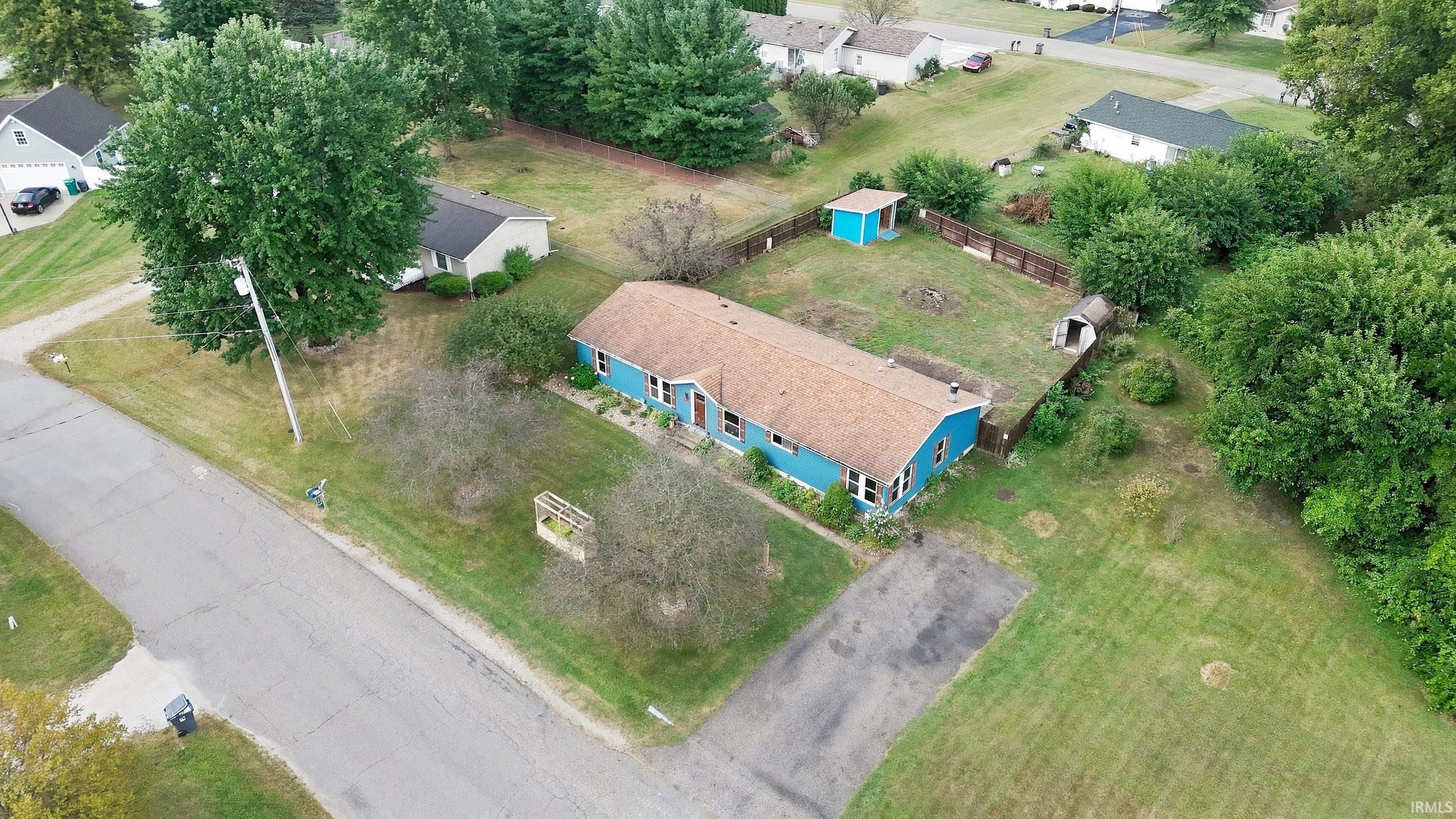 Ranch-style residence featuring a brown shingle roof and light blue exterior siding